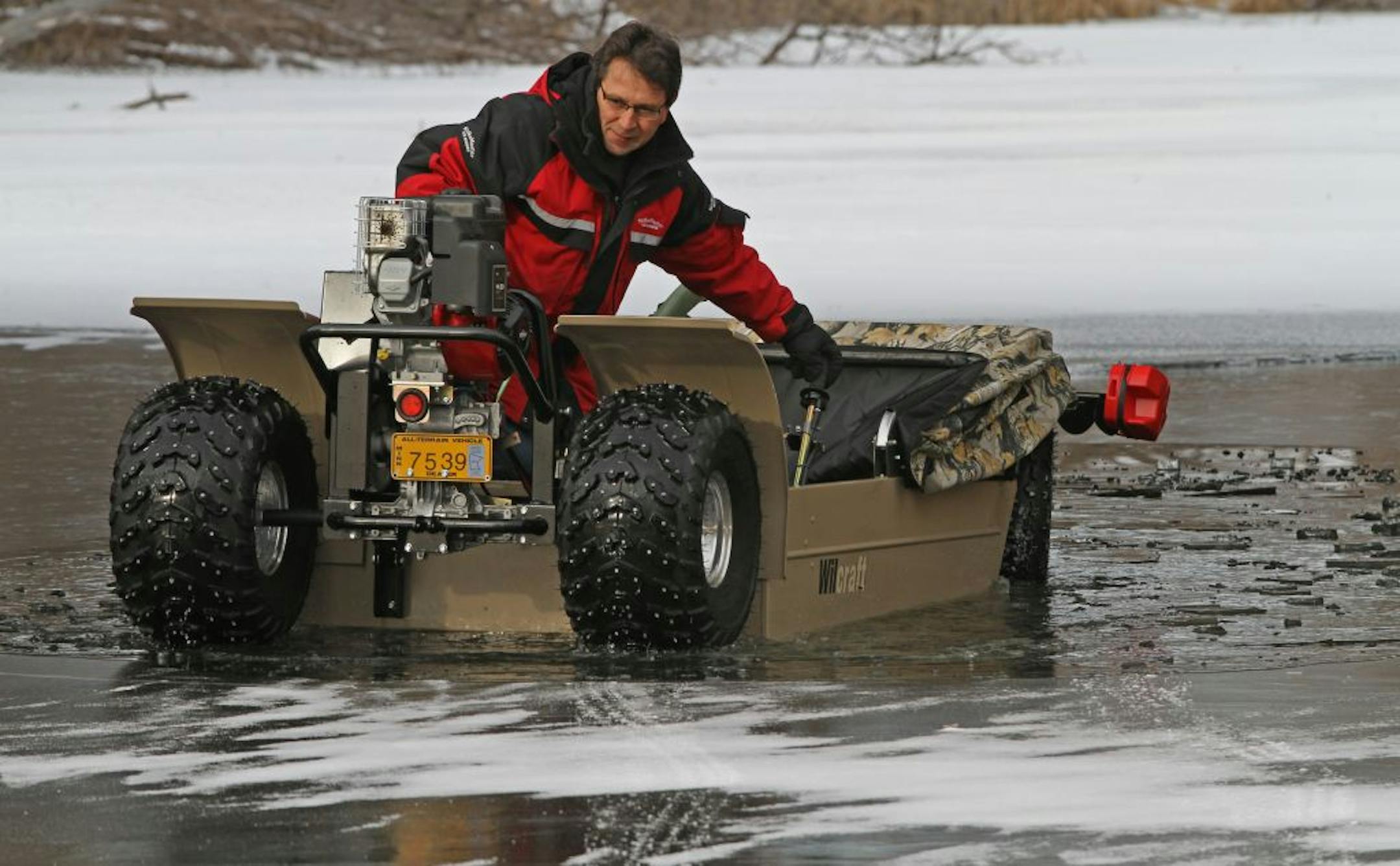 Tom Roering, President of Multifarious, maker of the Wilcraft, described the features of the ice fishing vehicle on frozen Spoon Lake in Maplewood. The Wilcraft features mobile ice fishing along with the safety of a vehicle that floats in case of breaking through thin ice.