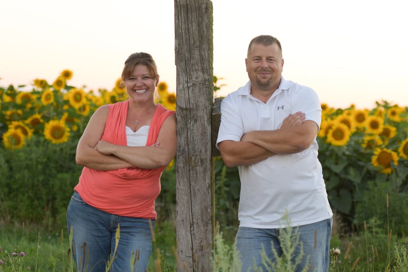 On the family pictures the names are Jenni and Tom Smude in the sunflowers. Credit: Smude Photography