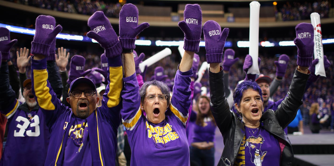 Wearing mittens that everyone attending the orientation received, Super Bowl LII volunteers Domingo Martinez, Gail Martinez, and Carol Prettyman, from left, chanted "Bold" and "North" during the program. ] JEFF WHEELER &#xef; jeff.wheeler@startribune.com All 10,000 volunteers who are part of Crew 52, the Super Bowl LII volunteers, were together for the first time for a rally and orientation at Xcel Energy Centre in St. Paul Sunday afternoon, November 12, 2017.