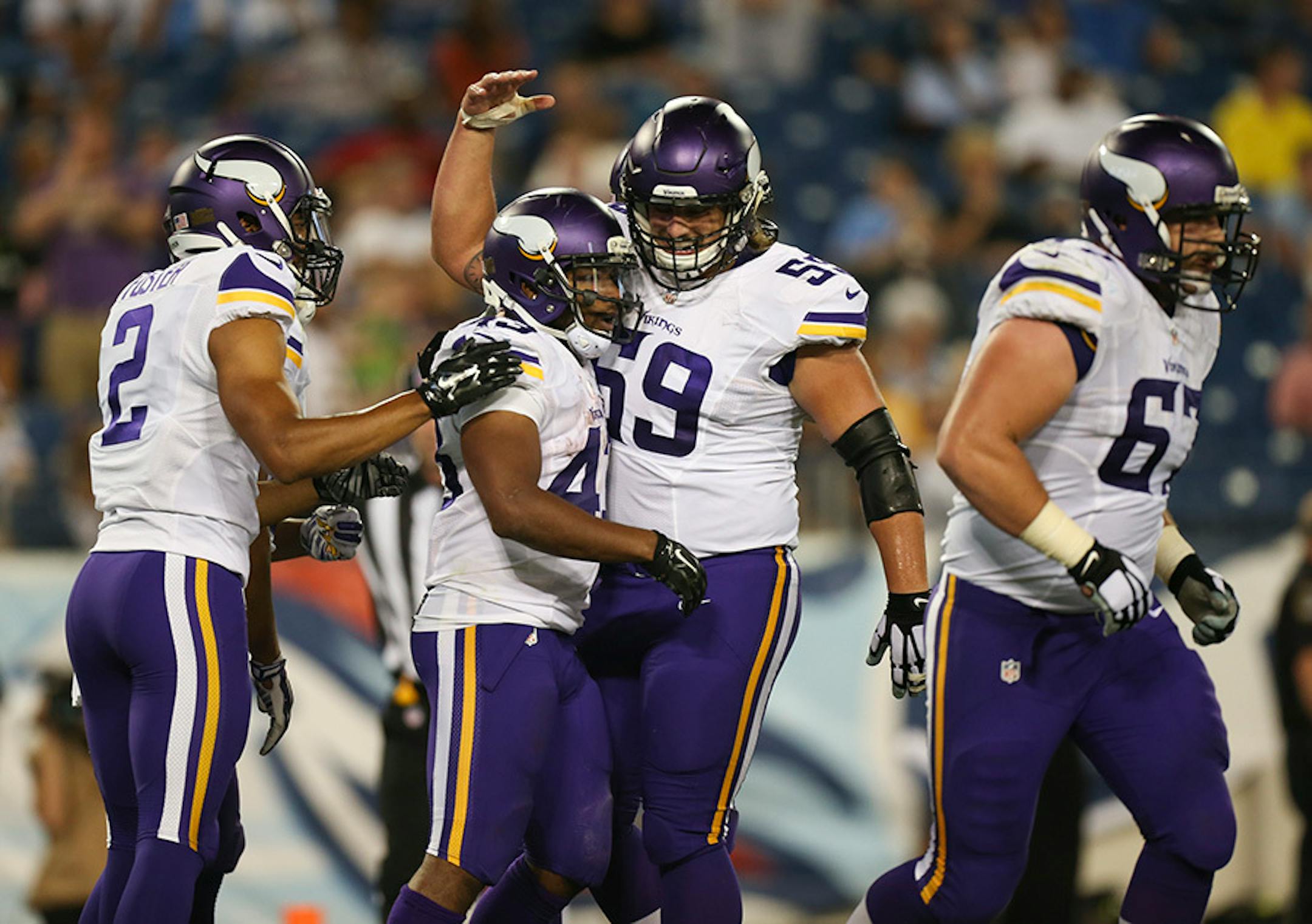 Vikings running back Dominique Williams (43) was congratulated by teammates Casey Matthews (59) and Donte Foster (2) after his 14 yard touchdown reception in the third quarter Thursday night.