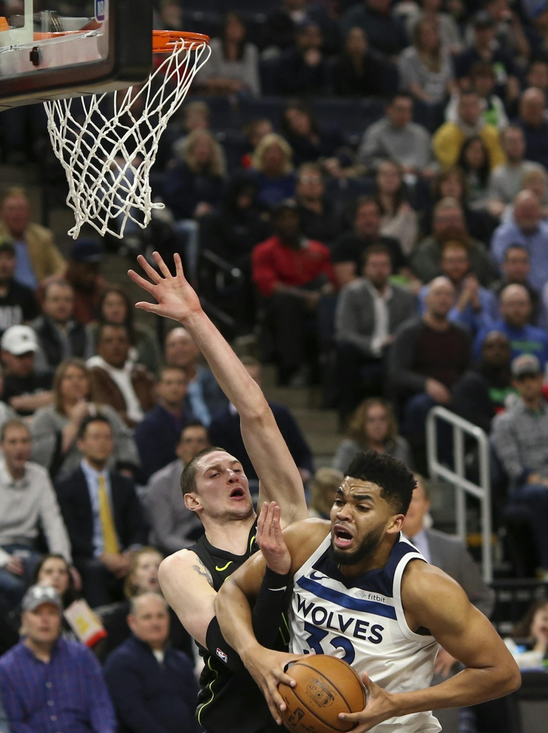 Minnesota Timberwolves center Karl-Anthony Towns (32) went up for a first half basket while defended by Atlanta Hawks forward Mike Muscala (31).