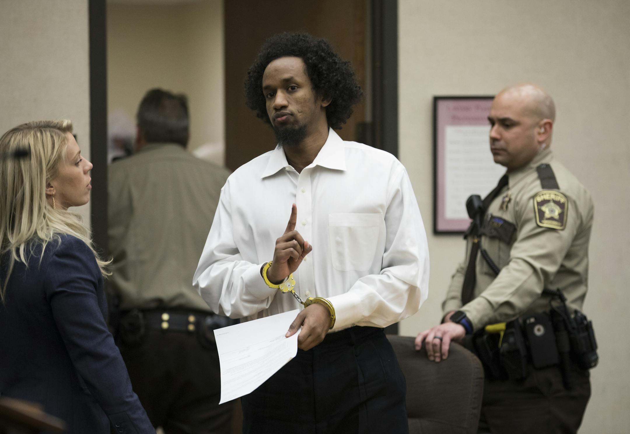Mahad Abdiraham raised his index finger as he was photographed leaving the courtroom after his sentencing in the stabbing of two men at the Mall of America on Friday, February 16, 2018 at the Hennepin County Government Center in Minneapolis, Minn. Raising an index figure is a common gesture in the Muslim community but has lately been used by ISIS to promote their fundamentalist views. ] RENEE JONES SCHNEIDER ï renee.jones@startribune.com