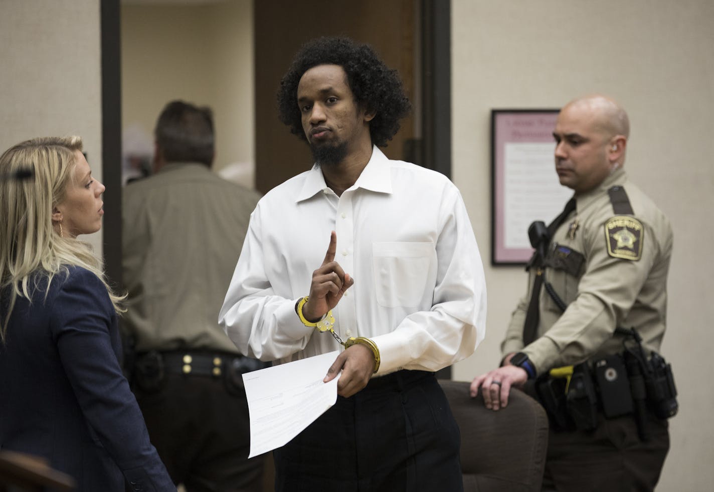 Mahad Abdiraham raised his index finger as he was photographed leaving the courtroom after his sentencing in the stabbing of two men at the Mall of America on Friday, February 16, 2018 at the Hennepin County Government Center in Minneapolis, Minn. Raising an index figure is a common gesture in the Muslim community but has lately been used by ISIS to promote their fundamentalist views. ] RENEE JONES SCHNEIDER &#xef; renee.jones@startribune.com