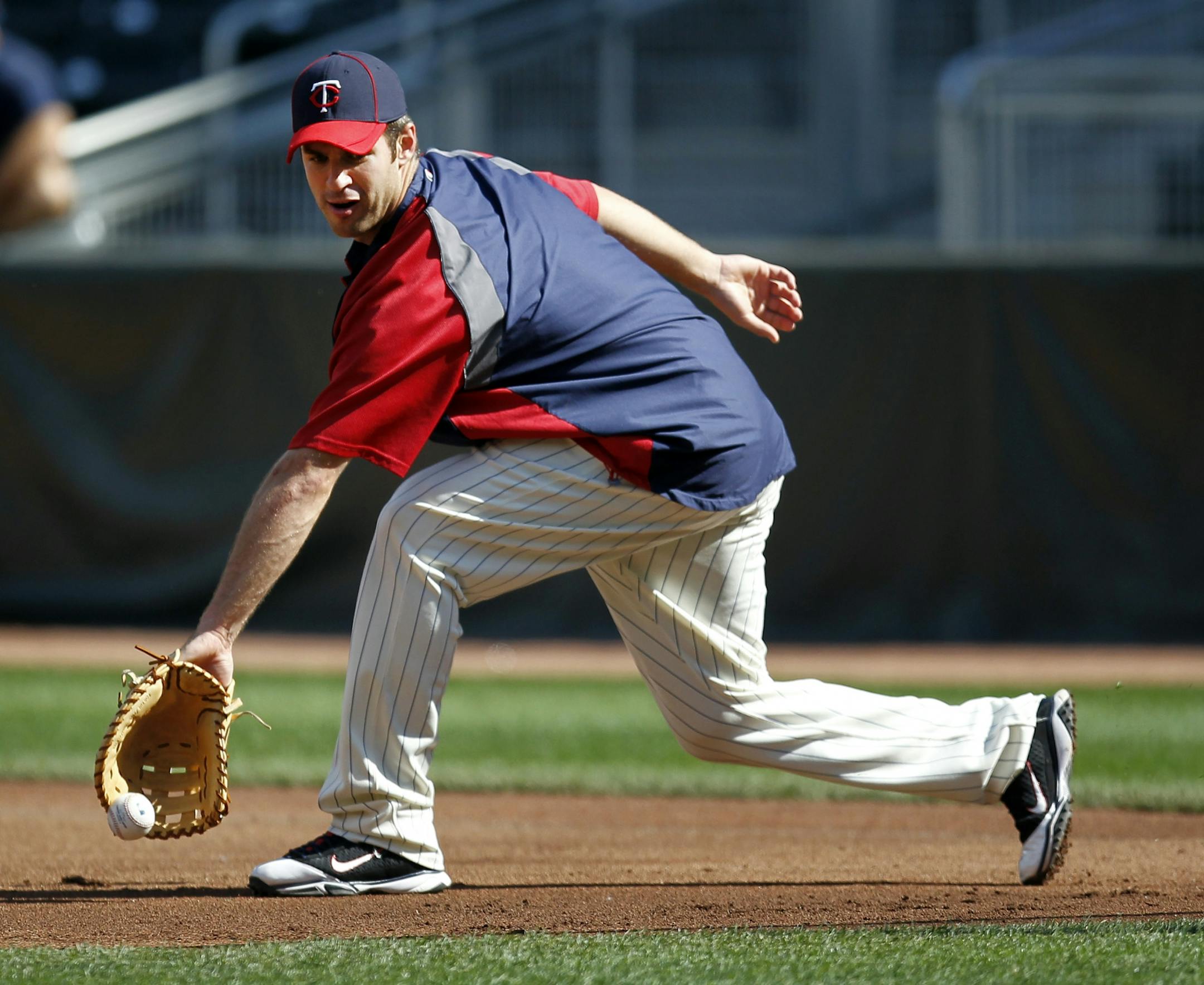 Twins catcher Joe Mauer took infield at first base before Monday's game against the Dodgers at Target Field.