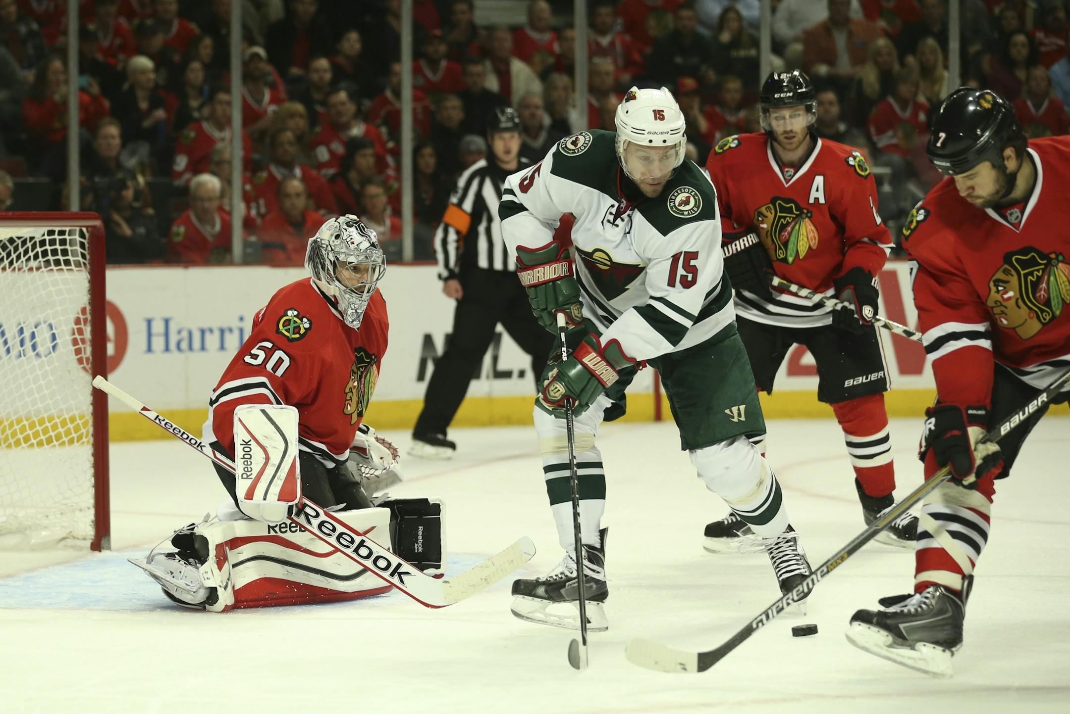 Minnesota Wild left wing Dany Heatley (15) tried to get a handle on a puck in front of the Hawks net while defended by Chicago's Brent Seabrook (7) Sunday afternoon at United Center in Chicago.