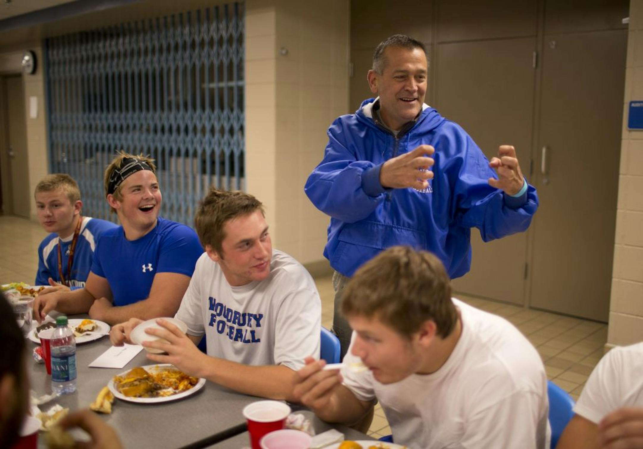 Glen Moon — standing behind his son, Woodbury QB Sawyer Moon — teased one of Sawyer's teammates at a team dinner. Glen never misses a Royals game despite having a terminal case of esophageal cancer, with humor being a favorite coping mechanism. "I joke about it because it's a reality I can't change," he said.
