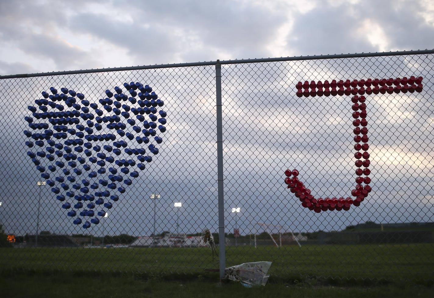 A memorial made of drinking cups for Lakeville goal keeper Joseph Dokken was placed in the fence near the stadium as Lakeville played Rochester Mayo in a match Thursday night. ] JEFF WHEELER &#xef; jeff.wheeler@startribune.com The Lakeville North High School boy's soccer team hosted Rochester Mayo in their first game of the season Thursday night, August 24, 2017 in Lakeville. It was the team's first game since the untimely deaths of both their assistant coach, Seamus Tritchler, and goal keeper J