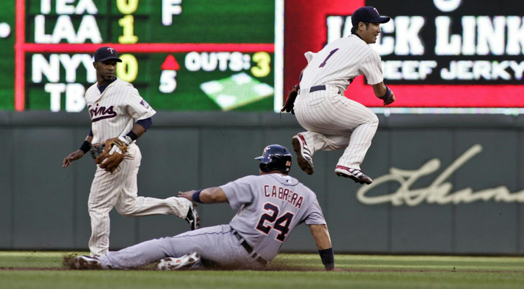 Twins second baseman Tsuyoshi Nishioka jumped over Detroit's Miguel Cabrera in the second inning Thursday.