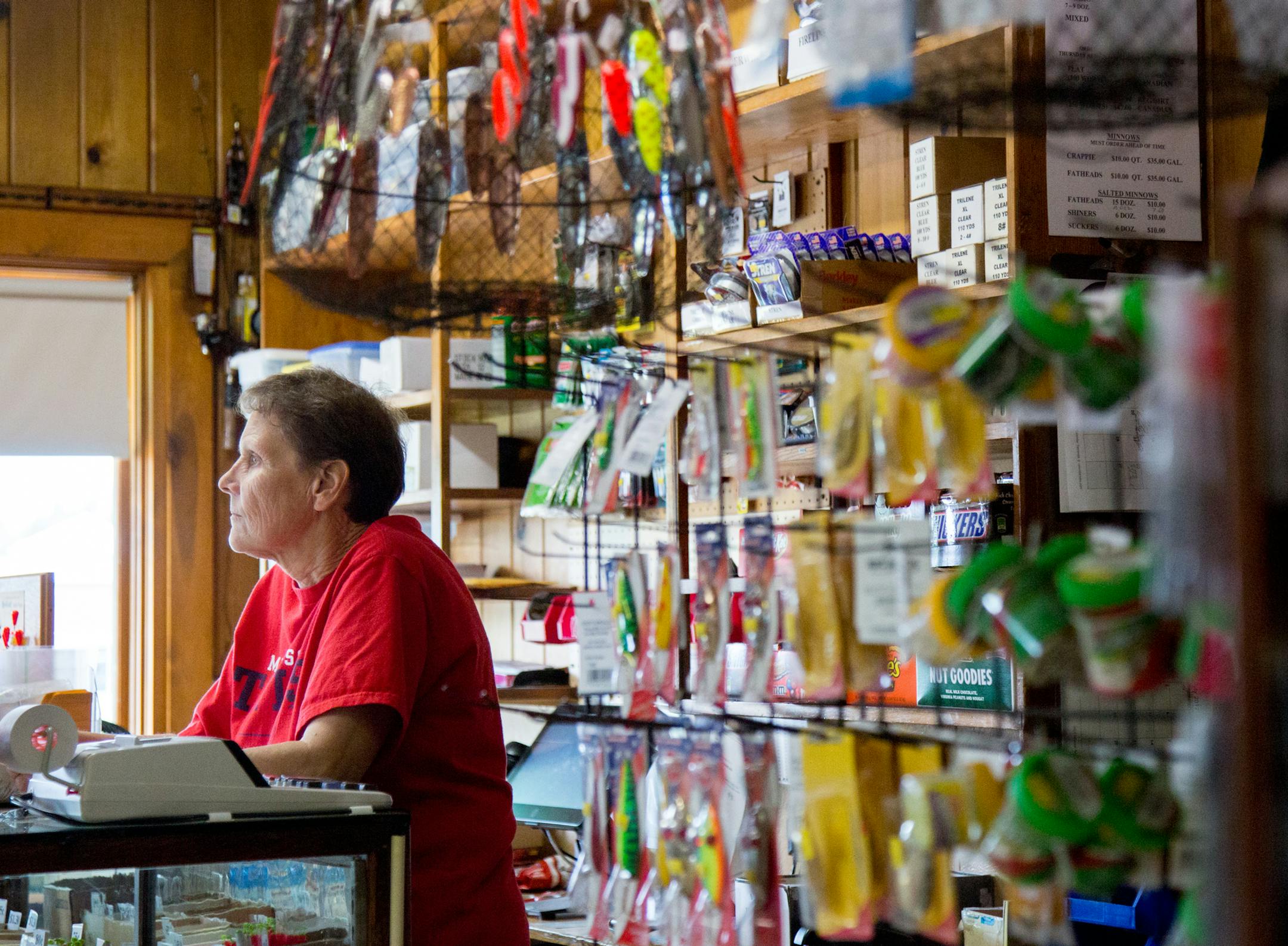 Joanne Rousseau looks out the window and waits for customers at Ebner's Live Bait in Elk River. Rousseau has worked at the shop since 1979 but bought the shop from her parents in 1993. ] COURTNEY PEDROZA • courtney.pedroza@startribune.com Joanne Rousseau owner of Ebner's Live Bait in Elk River; July 21, 2017. Rousseau has worked at the shop since 1979 but bought the shop from her parents in 1993.