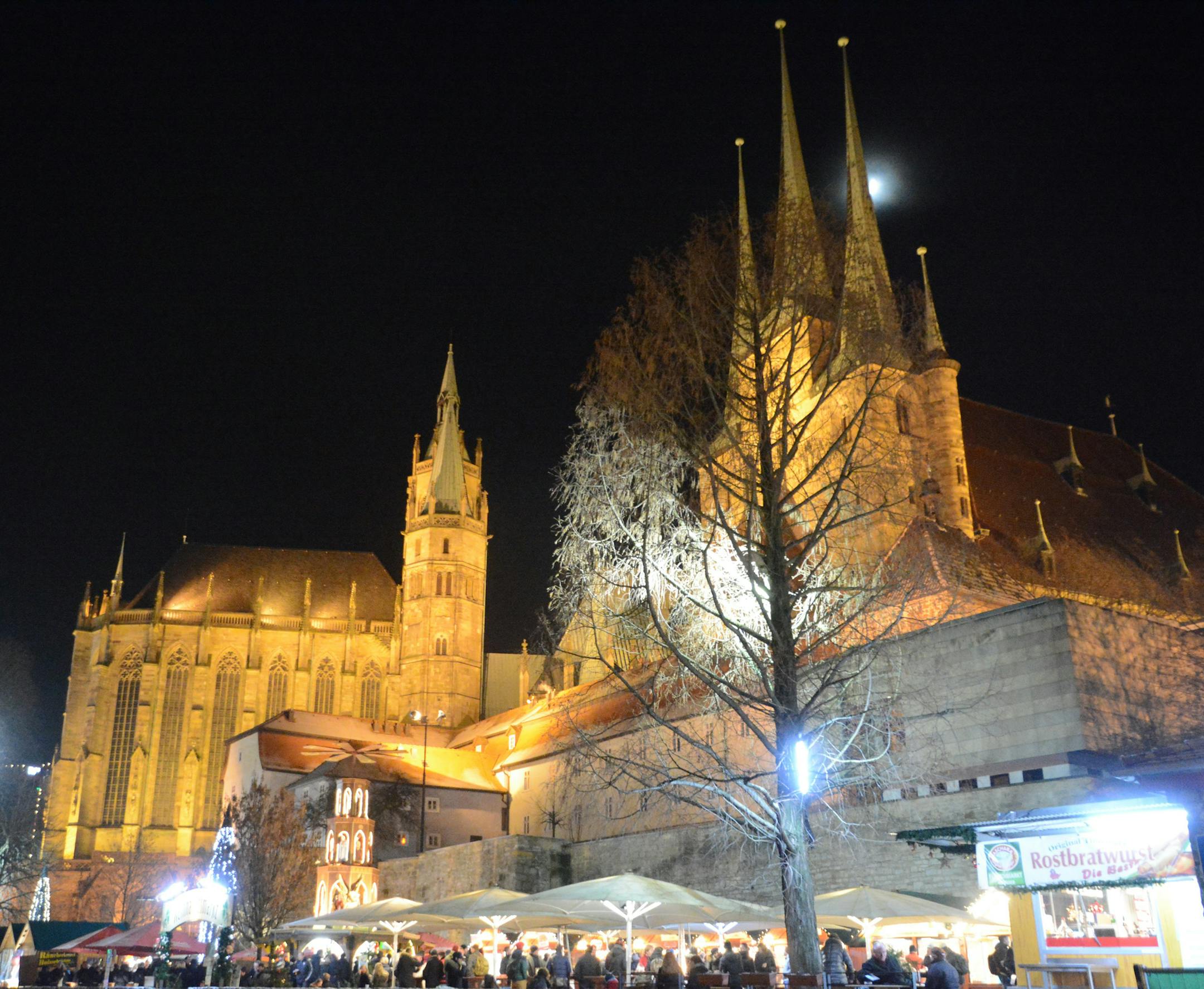 The early Gothic spires of Erfurt Cathedral (left) and St. Severi Church (right), which were built, enlarged and renovated between 742 and 1495, provide the dramatic backdrop for the Christmas market in Erfurt, Germany. Photo by