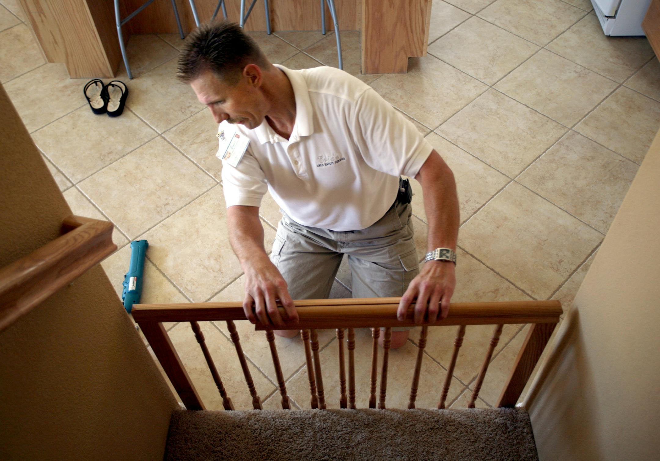 Eric Quint stumbled into his career as a childproofer six years ago when a cousin showed him all the precautions he'd installed to keep his baby safe. Quint installs a child safety gate at a Roseville, California home on August 17, 2007. (Randy Pench/Sacramento Bee/MCT) ORG XMIT: 1047893