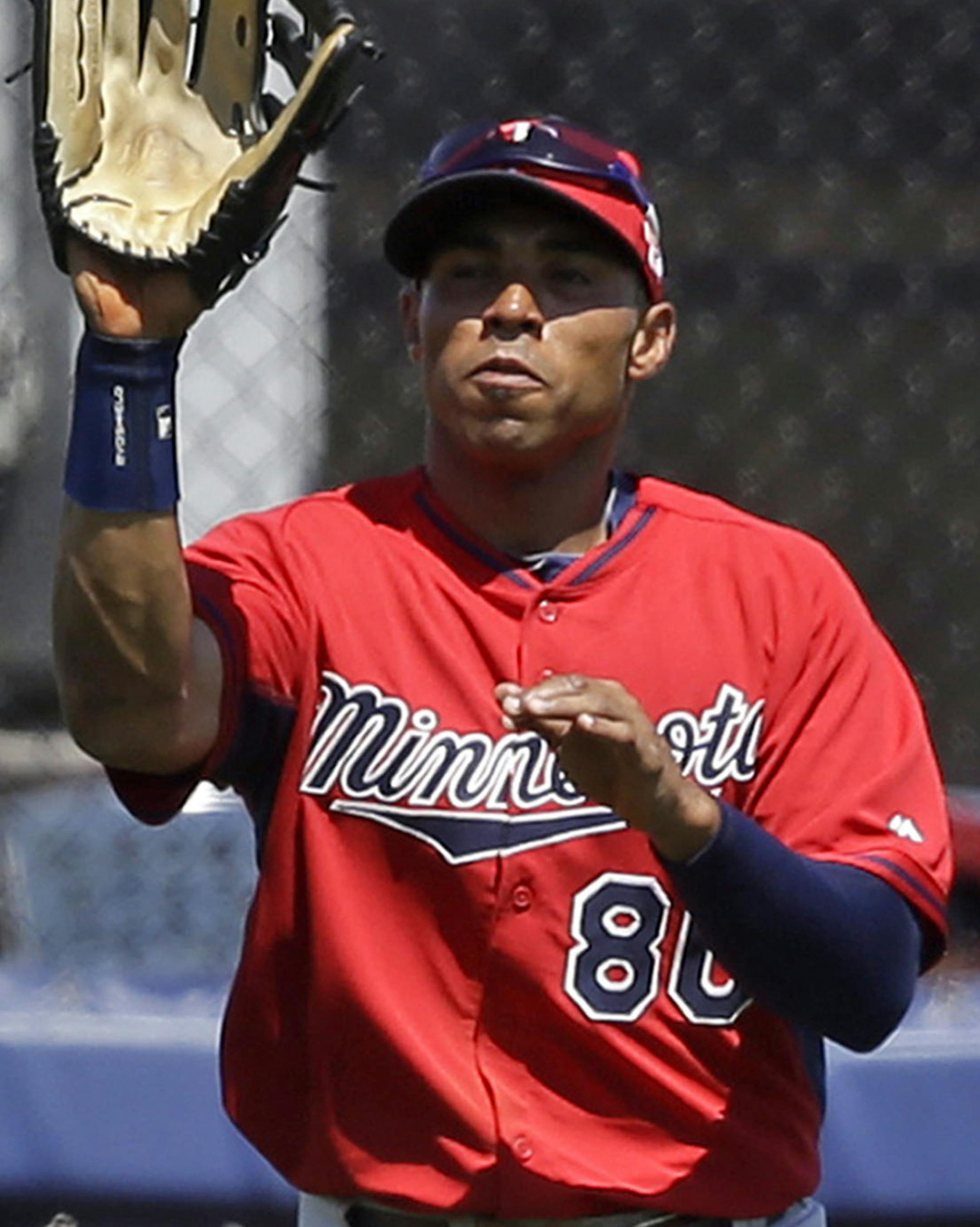 Minnesota Twins right fielder Jermaine Mitchell (80) catches a pop fly by Tampa Bay Rays Matt Joyce in the second inning of an exhibition baseball game in Port Charlotte, Fla., Tuesday, March 11, 2014. (AP Photo/Gerald Herbert)