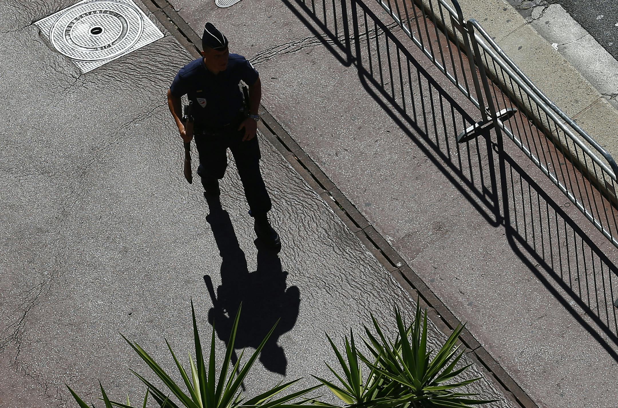 A police officer patrolls at the scene where a truck mowed through revelers in Nice, southern France, Friday, July 15, 2016. A large truck mowed through revelers gathered for Bastille Day fireworks in Nice, killing more than 80 people and sending people fleeing into the sea as it bore down for more than a mile along the Riviera city's famed waterfront promenade. (AP Photo/Francois Mori) ORG XMIT: MIN2016071514112231
