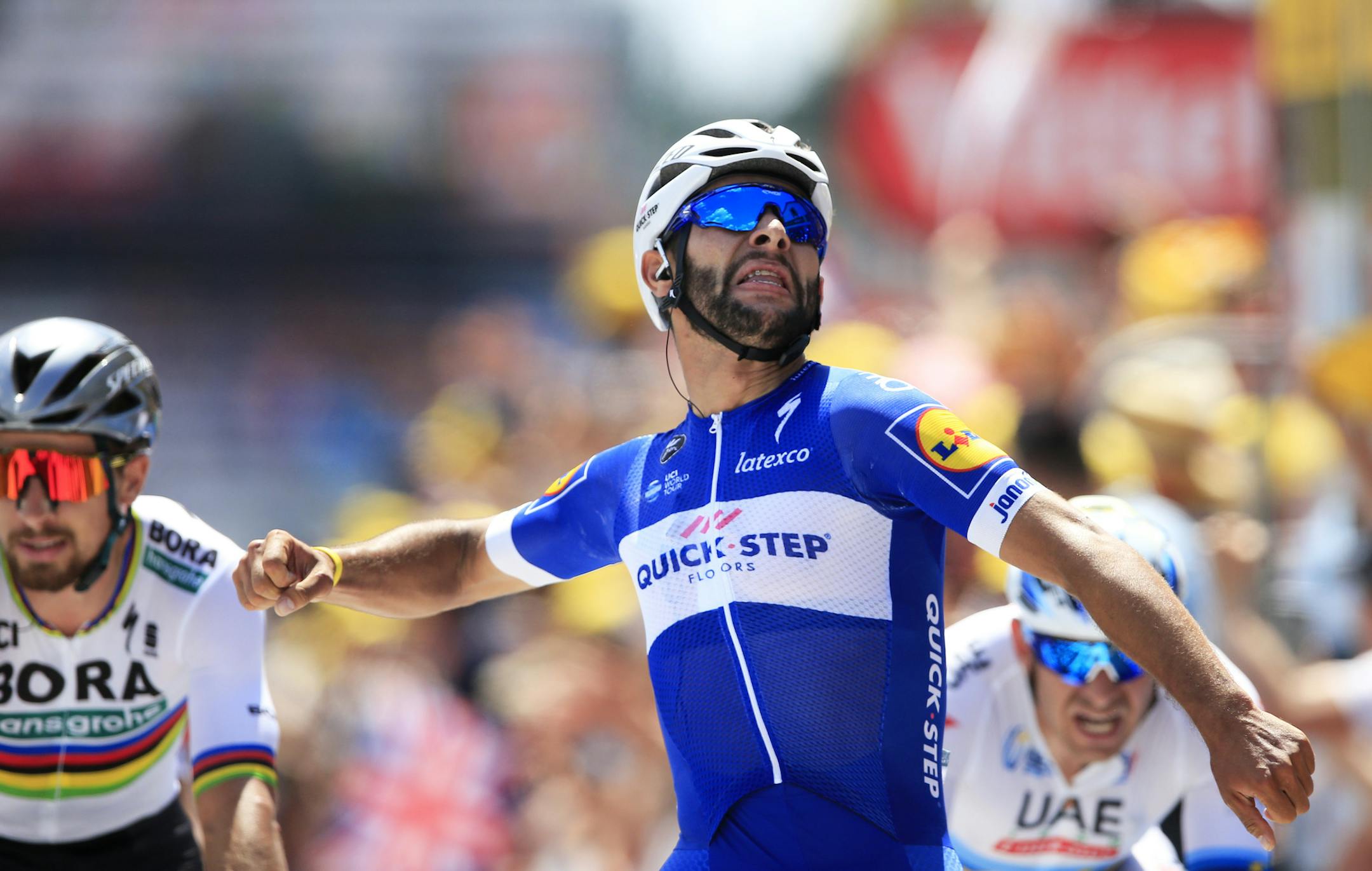 Colombia's Fernando Gaviria crosses the finish line ahead of Peter Sagan of Slovakia, left, and Norway's Alexander Kristoff, right, to win the first stage of the Tour de France cycling race over 201 kilometers (124.9 miles) with start in Noirmoutier-en-L'Ile and finish in Fontenay Le-Comte, France, Saturday, July 7, 2018. (AP Photo/Peter Dejong)