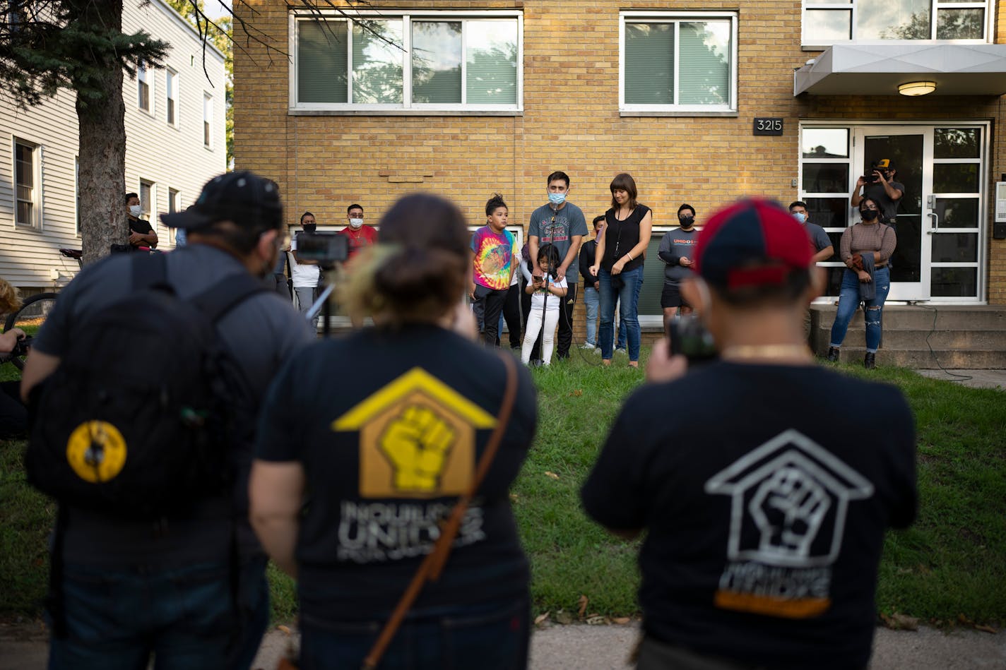 Heyler Sales, a tenant in the building behind him, spoke with his son next to him about how their apartment had roaches and mice and other issues. At right was Jennifer Arnold, who was interpreting the residents' remarks. ] JEFF WHEELER • jeff.wheeler@startribune.com