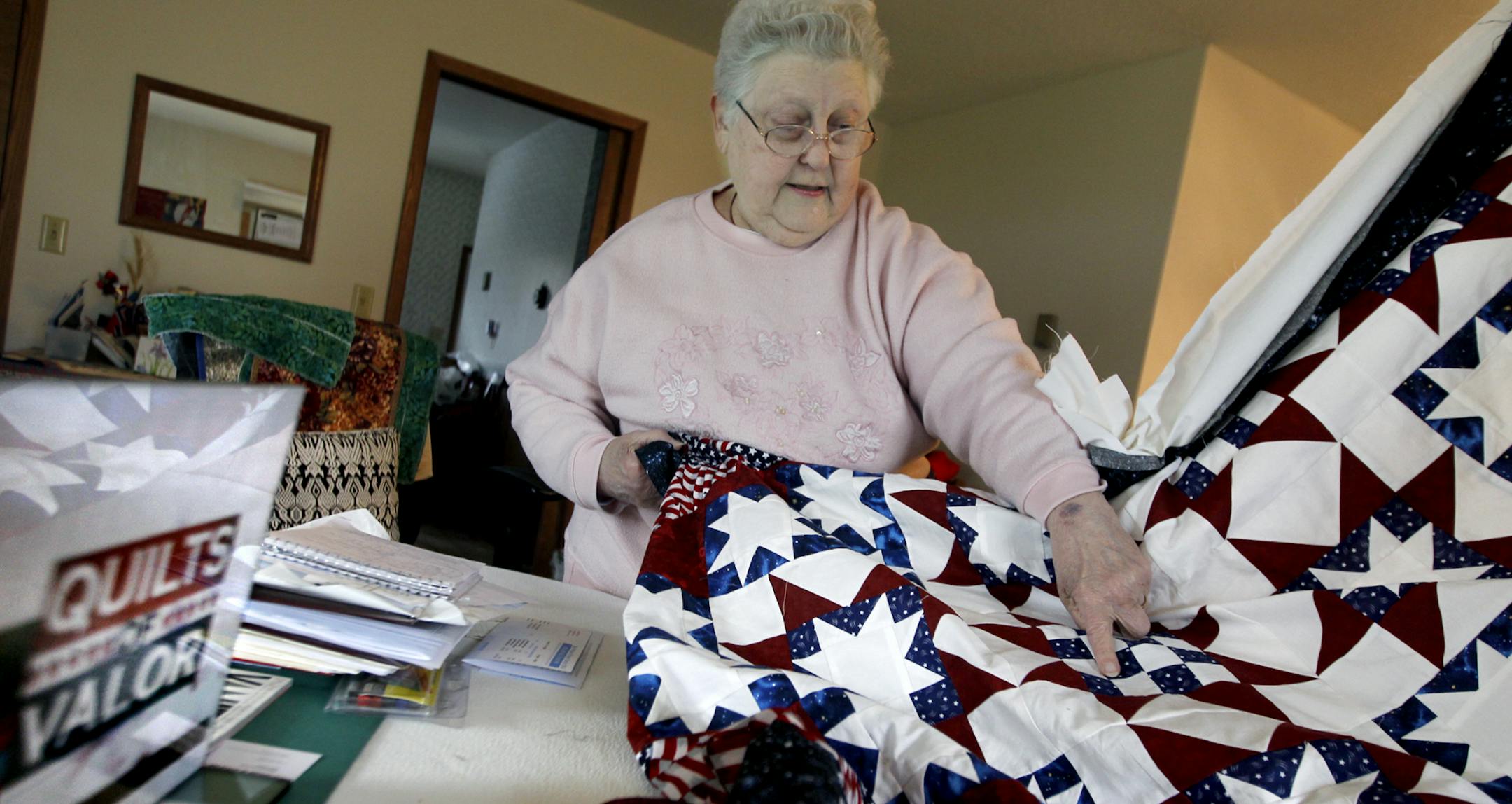 Dorelle Malmberg showed off the intricate designs and work that goes into the quilts that are being made for returning Litchfield soldiers, Tuesday, April 29, 2014 in Litchfield, MN. ] (ELIZABETH FLORES/STAR TRIBUNE) ELIZABETH FLORES • eflores@startribune.com