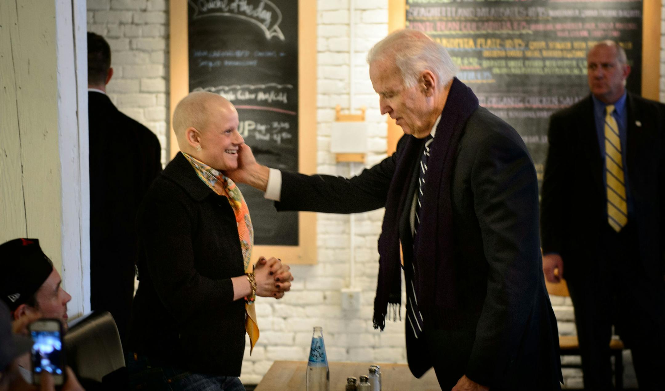 Vice President Joe Biden greeted Bessie Alyeshmerni, who is battling cancer at Moose & Sadie's cafe in Minneapolis on Wednesday.