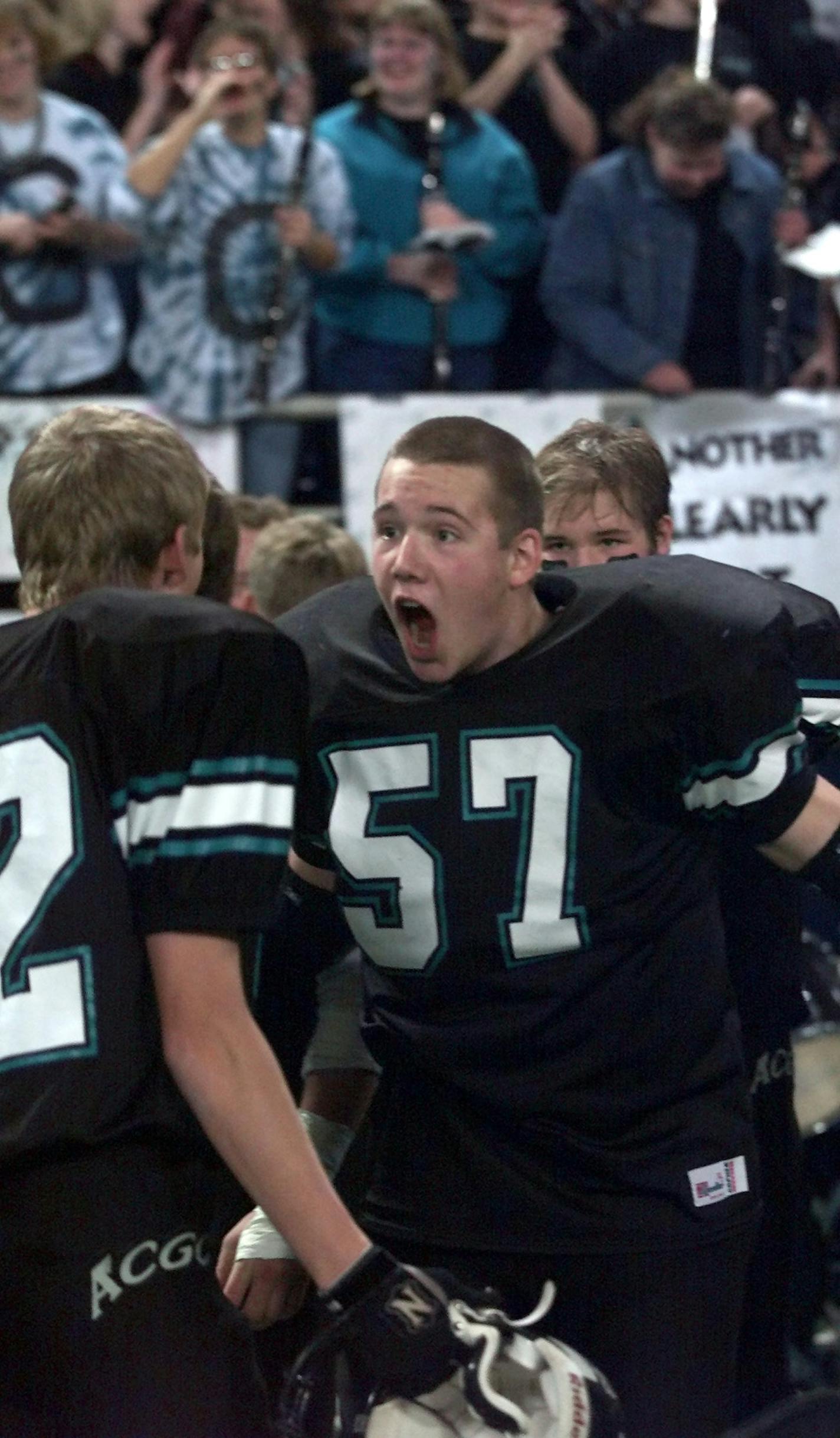 IN THIS PHOTO: Minneapolis, MN., Friday, 11/23/2001. Class 2A state championionship football game, Atwater-Cosmos-Grove City vs. Windom. Atwater-Cosmos-Grove City's players celebrated at the end of the game after winning the Class 2a championship.