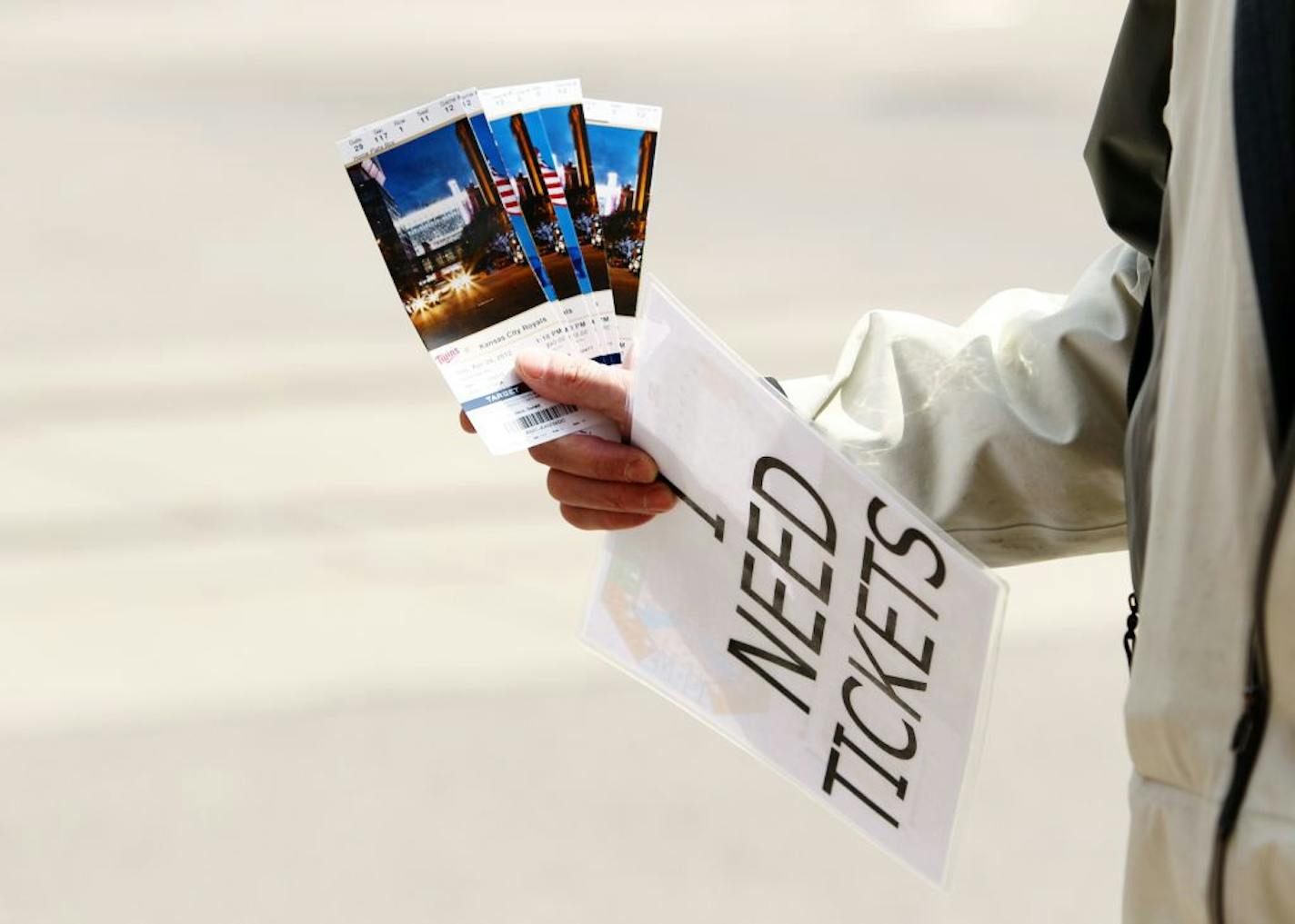 A scalper tries to buy and sell tickets to a Twins game on the corner of 5th Street and Hennepin Avenue in downtown Minneapolis, Sunday, April 29, 2012.