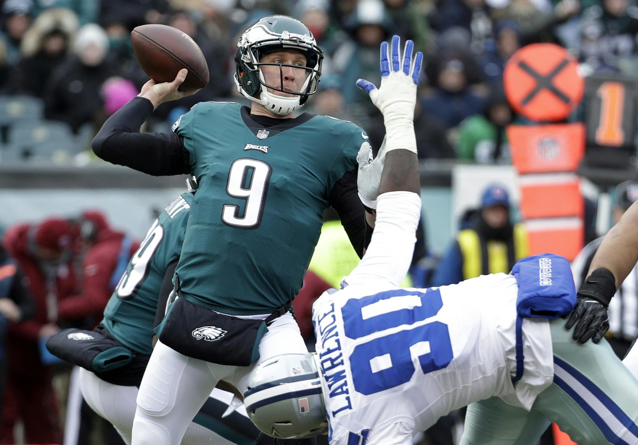 FILE - In this Dec. 31, 2017, file photo, Philadelphia Eagles' Nick Foles (9) throws a pass over Dallas Cowboys' DeMarcus Lawrence (90) during the first half of an NFL football game in Philadelphia. The Eagles earned the top seed in the NFC playoffs for the first time since 2004. (AP Photo/Chris Szagola, File)