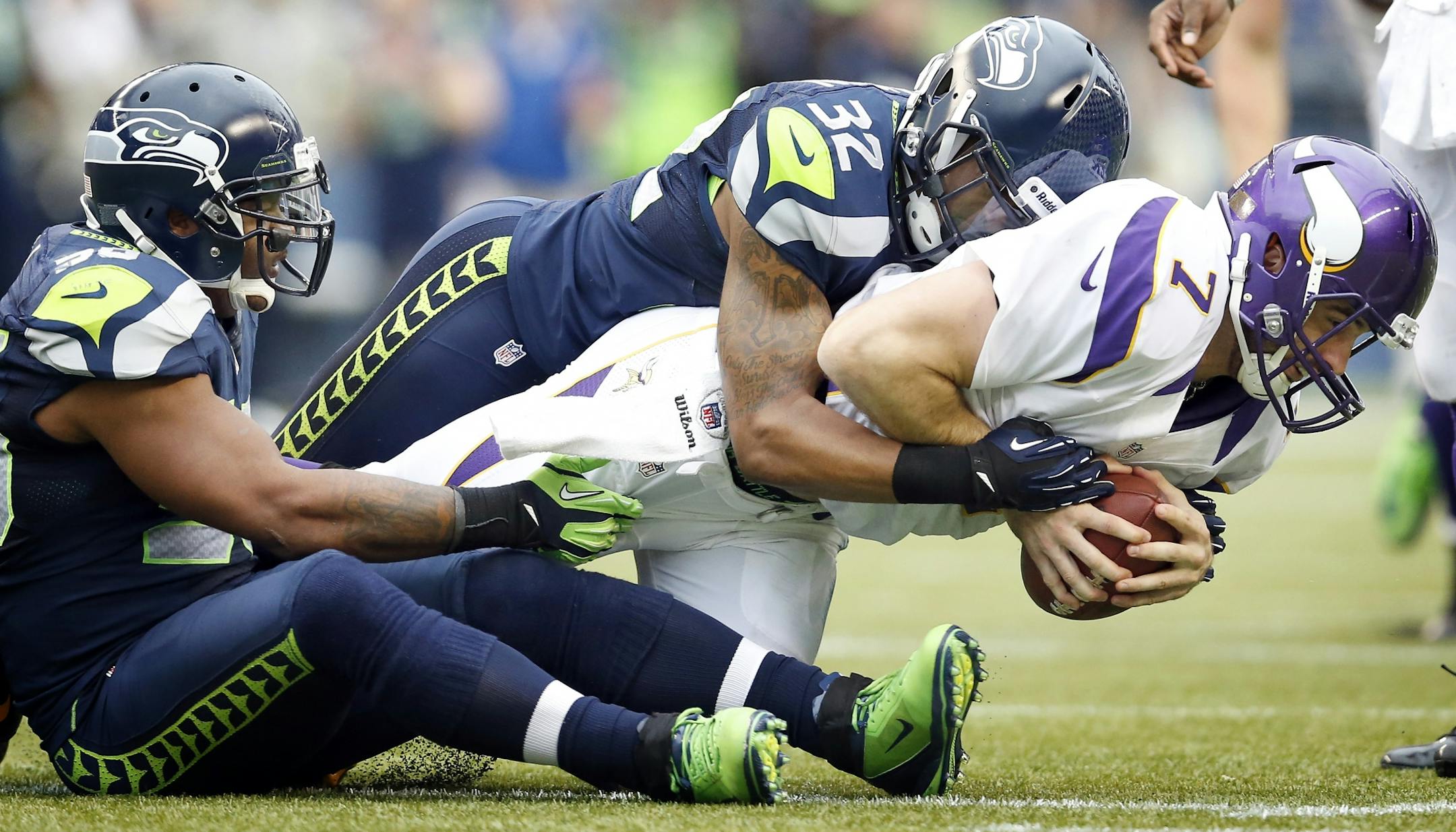 Vikings quarterback Christian Ponder (7) was finished off by Jeron Johnson (32) after being sacked by Leroy Hill (56) and Bruce Irvin (51) in the third quarter on Sunday.