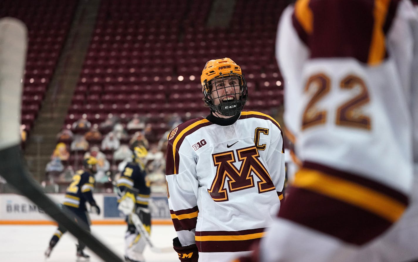 Minnesota forward Sammy Walker (9) cheered on forward Bryce Brodzinski (22) who scored on Michigan goaltender Strauss Mann (31) in the first period. ] ANTHONY SOUFFLE • anthony.souffle@startribune.com