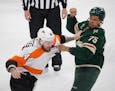 Minnesota Wild right wing Ryan Reaves (75) and Philadelphia Flyers left wing Nicolas Deslauriers (44) fought in the first period.