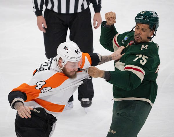 Minnesota Wild right wing Ryan Reaves (75) and Philadelphia Flyers left wing Nicolas Deslauriers (44) fought in the first period.