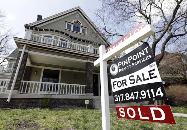 A "Sold" sign is posted outside a home in Indianapolis, Tuesday, April 9, 2013. Real estate agents say pent-up demand and low interest rates are leadi