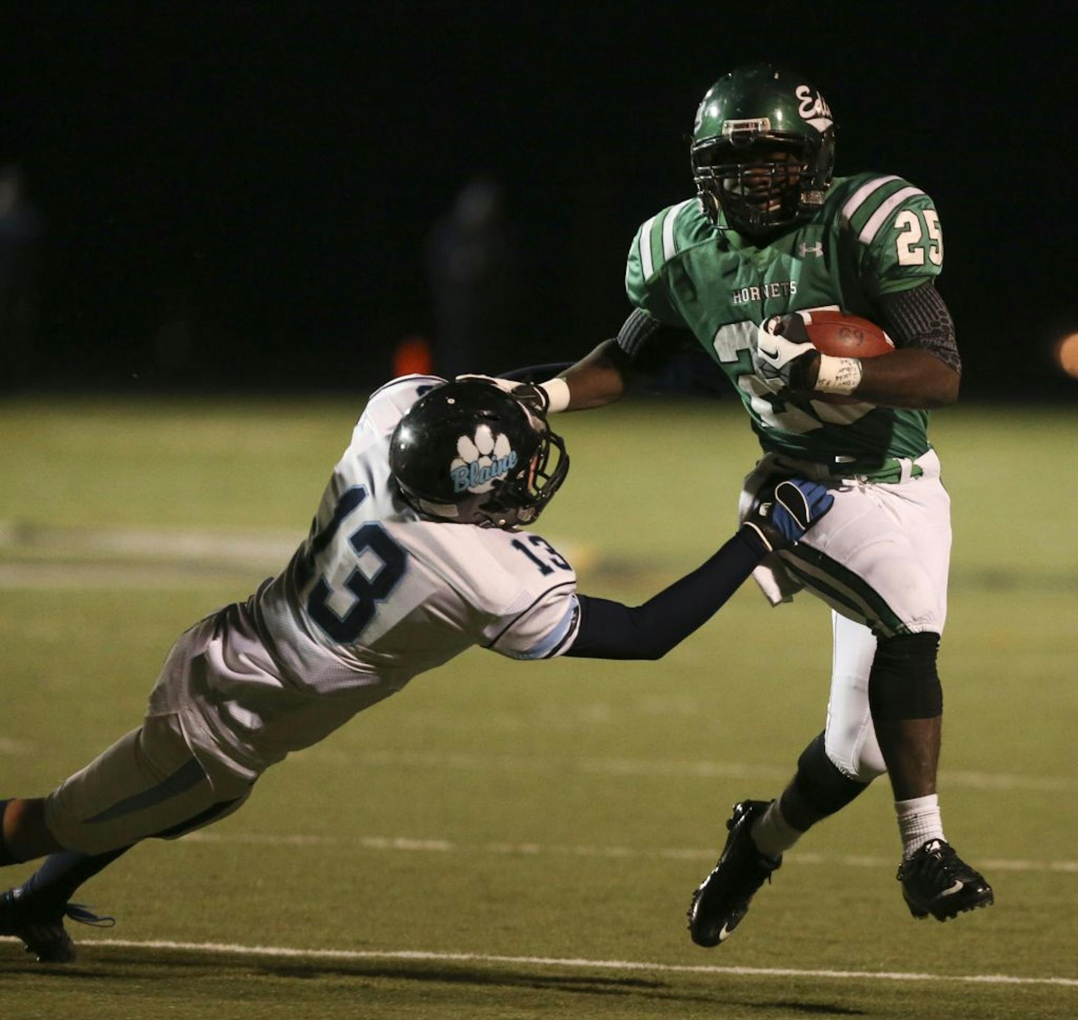 Edina's Kevin Placide stiff armed Blaine's Riley Hedstrom during the first half Kuhlman Field in Edina, Min., Friday November 2, 2012.