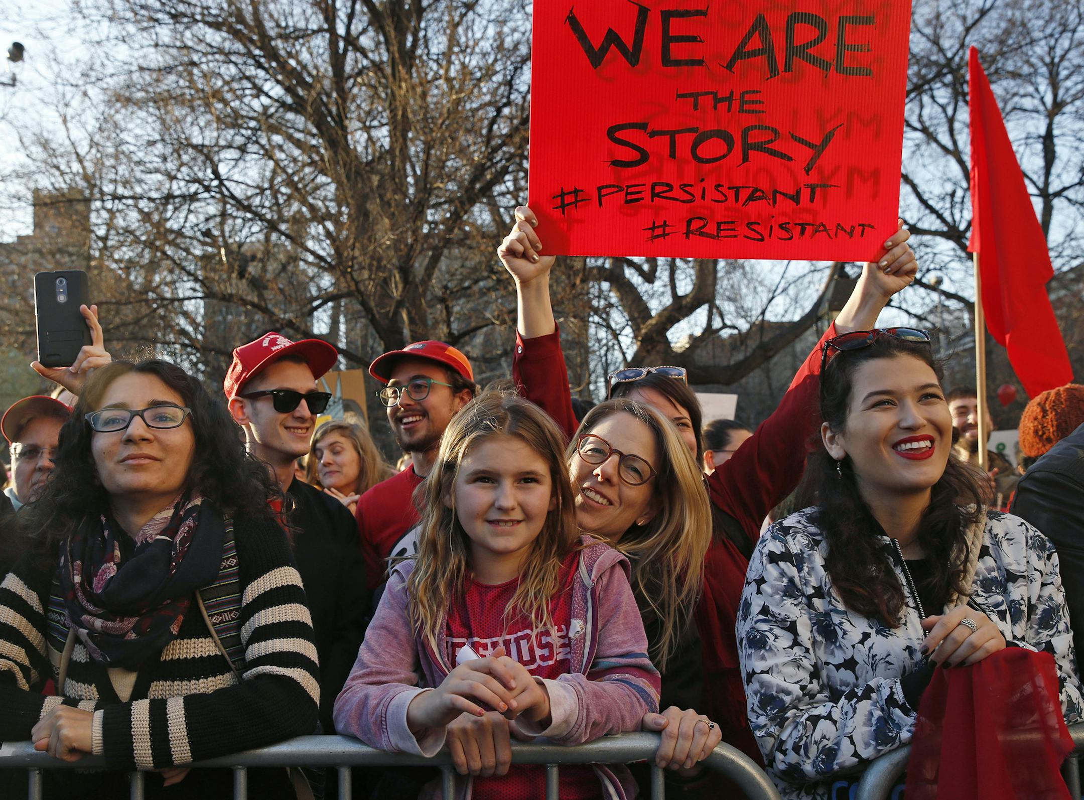 People listen to speakers during a rally on a Day Without Women, part of International Womens' Strike NYC, organized by a coalition of dozens of grassroots groups and labor organizations, Wednesday, March 8, 2017, at Washington Square Park in New York. (AP Photo/Kathy Willens) ORG XMIT: MIN2017032111201810