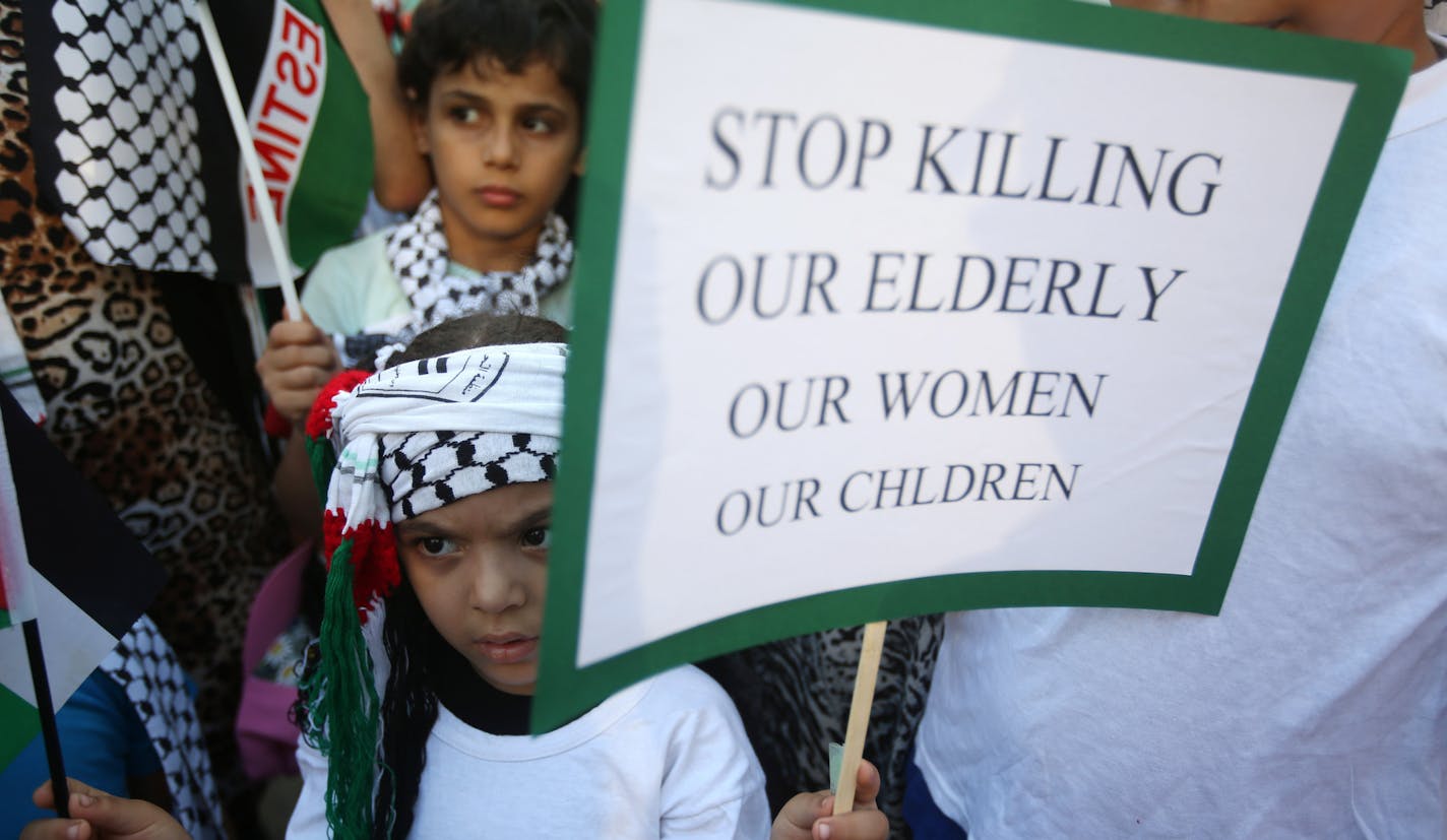 A Palestinian girl holds placard as she attends a protest against the war in Gaza, in Beirut, Lebanon, Monday July 21, 2014. The top Hamas leader in the Gaza Strip signaled Monday that the Islamic militant group will not agree to an unconditional cease-fire with Israel, saying that the aim of the current battle is to break a 7-year-old blockade of the Palestinian territory. (AP Photo/Hussein Malla)