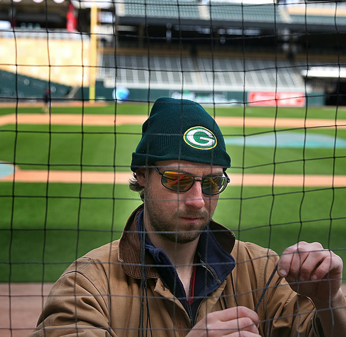 James Goible installed new, protective netting at Target Field along the first baseline, as mandated by Major League Baseball. Goible works for C and H Baseball, a contractor based in Florida. ]JIM GEHRZ &#xef; james.gehrz@startribune.com /Minneapolis, MN / March 22, 2016 2:00 PM - BACKGROUND INFORMATION: Twins putting up protective netting today at Target Field as mandated by Major League Baseball.