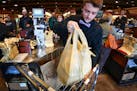 Alec Voight bagged groceries at Kowalski's in Minneapolis. A City Council member has reintroduced a proposal to charge five cents for each bag — pap