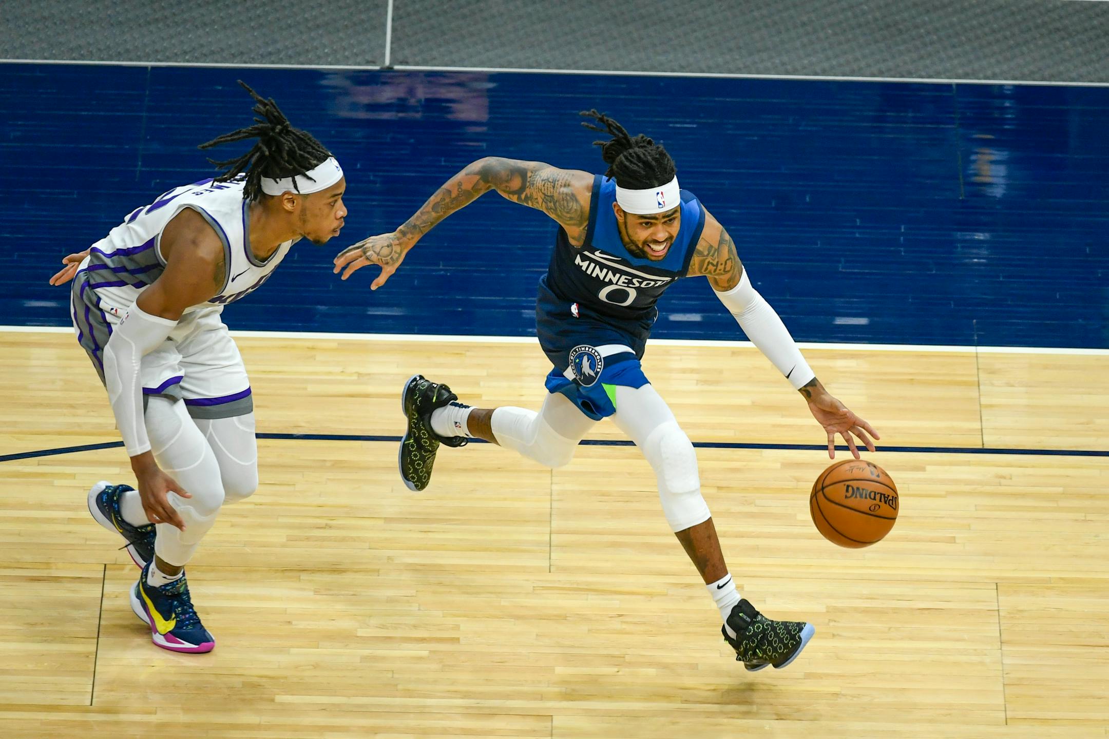 Minnesota Timberwolves guard D'Angelo Russell (0) drives past Sacramento Kings center Richaun Holmes&nbsp;during the second half of an NBA basketball game Monday, April 5, 2021, in Minneapolis. (AP Photo/Craig Lassig)