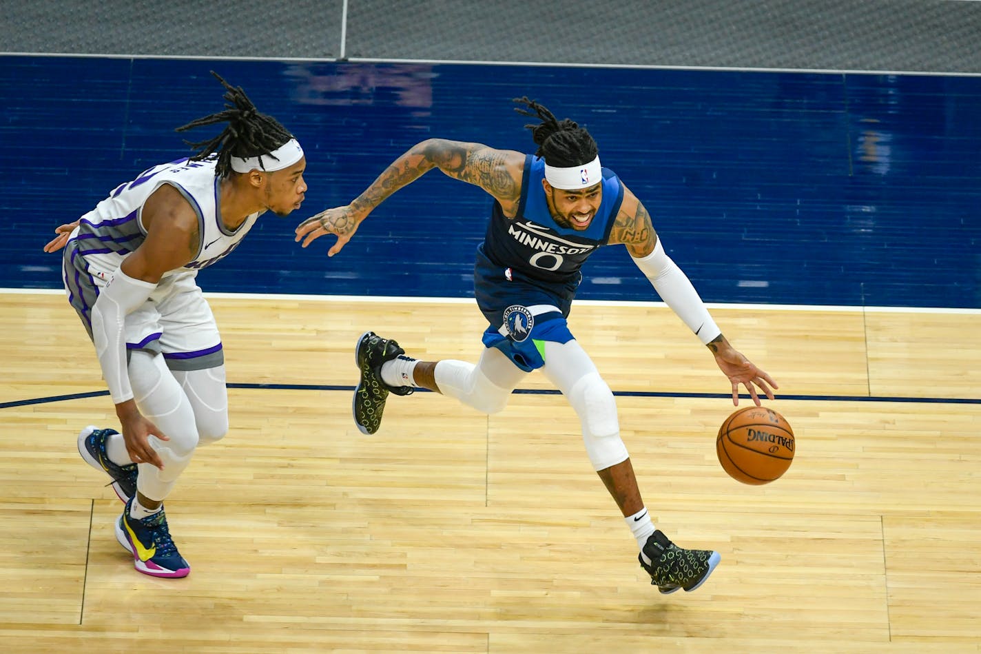 Minnesota Timberwolves guard D'Angelo Russell (0) drives past Sacramento Kings center Richaun Holmes&nbsp;during the second half of an NBA basketball game Monday, April 5, 2021, in Minneapolis. (AP Photo/Craig Lassig)