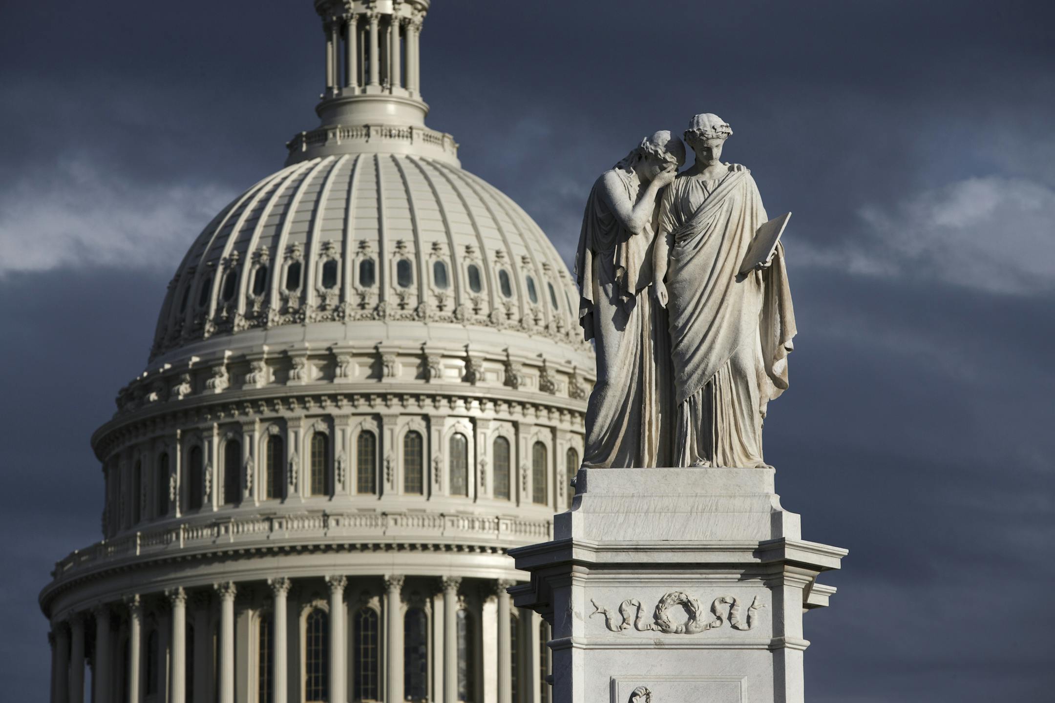 This Feb. 21, 2014, file photo shows the U.S. Capitol and the Peace Monument in Washington. The election of 2014 is an election of contradictions. A surly electorate holds President Barack Obama in low regard and gives Congress even worse marks, yet for all their anger, a historic few are motivated enough to vote and those that do are poised to "keep the bums in."(AP Photo/J. Scott Applewhite, File)