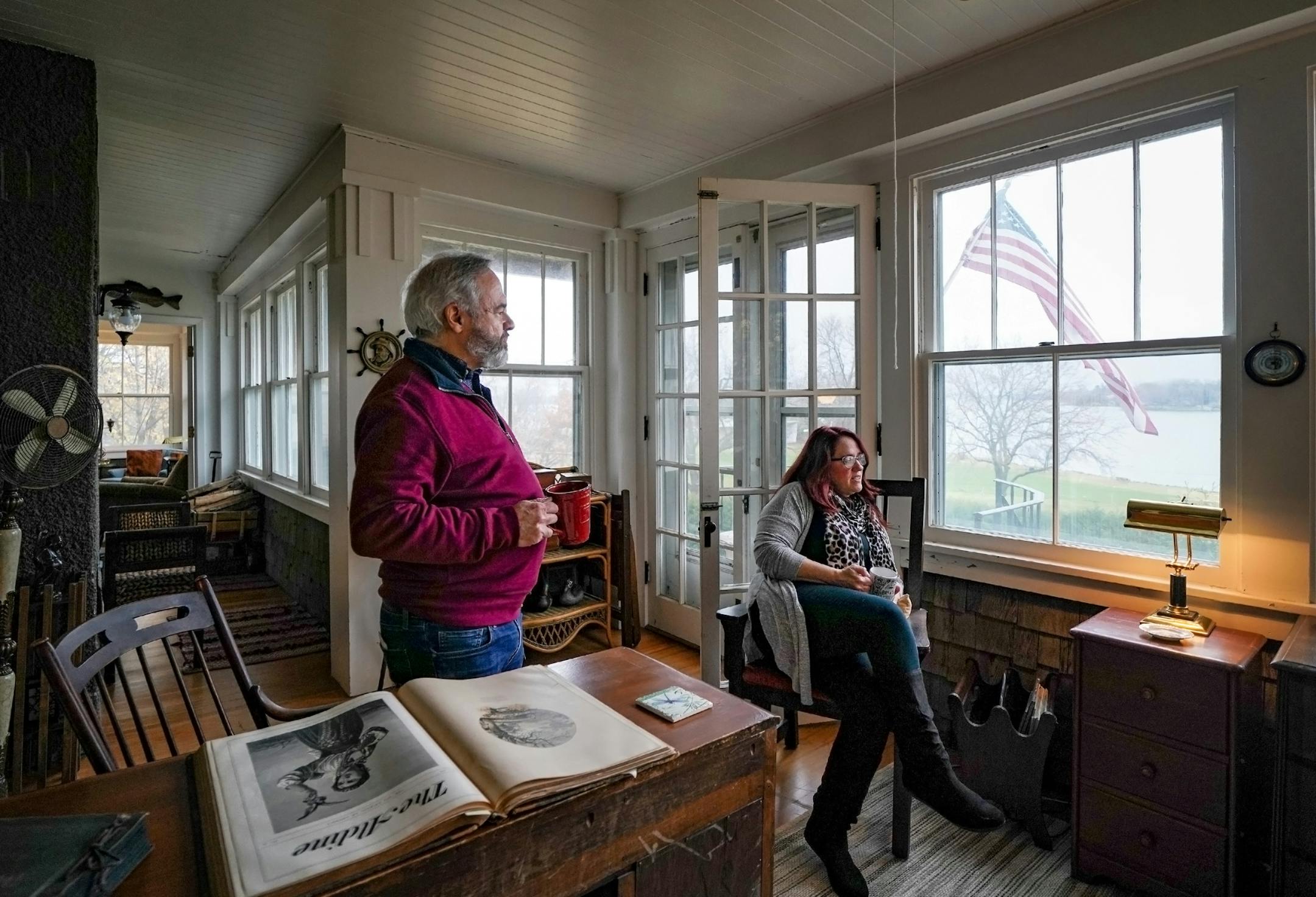 Peter Kizilos-Clift and Pam Koenig on the wraparound porch of the Excelsior house they hope to preserve.