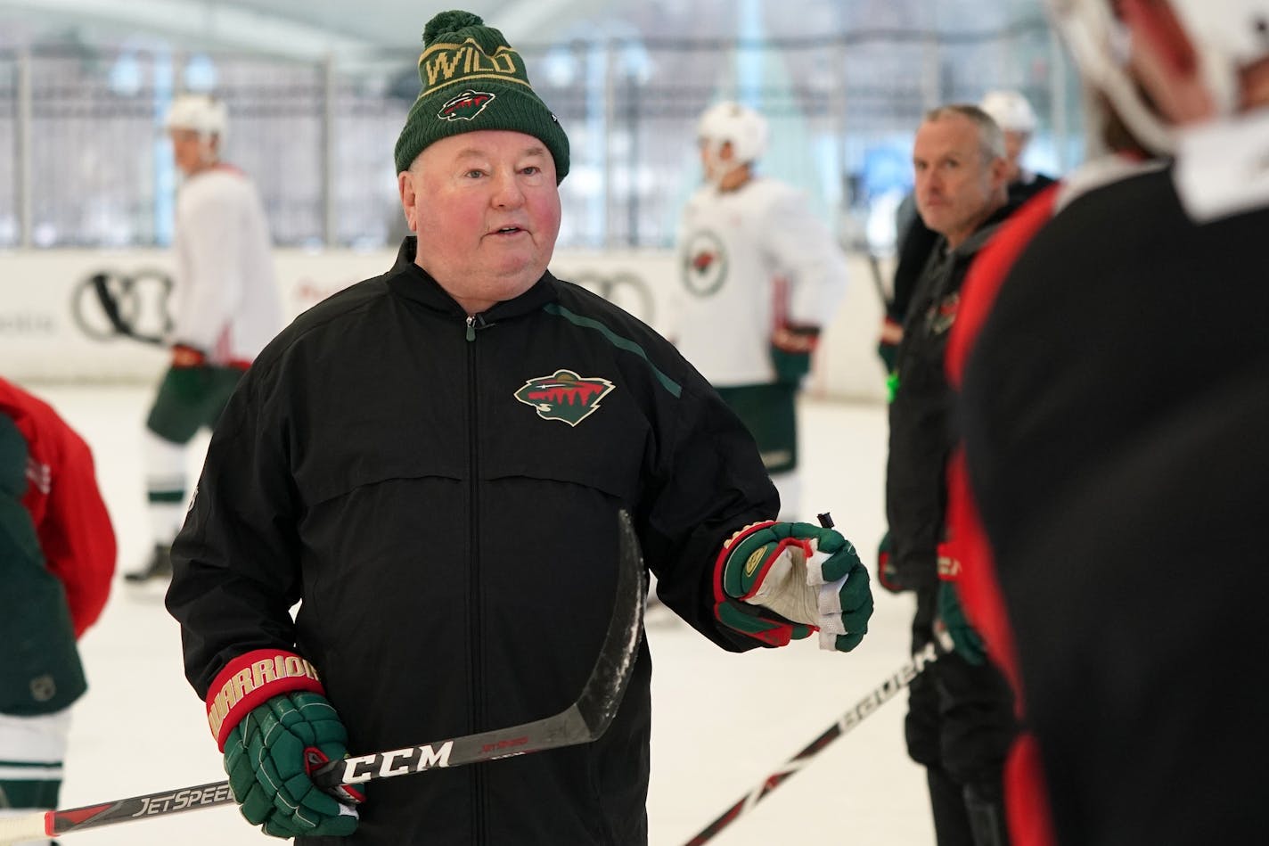 Minnesota Wild head coach Bruce Boudreau talked with his players along the boards during the Wild's outdoor practice Thursday.