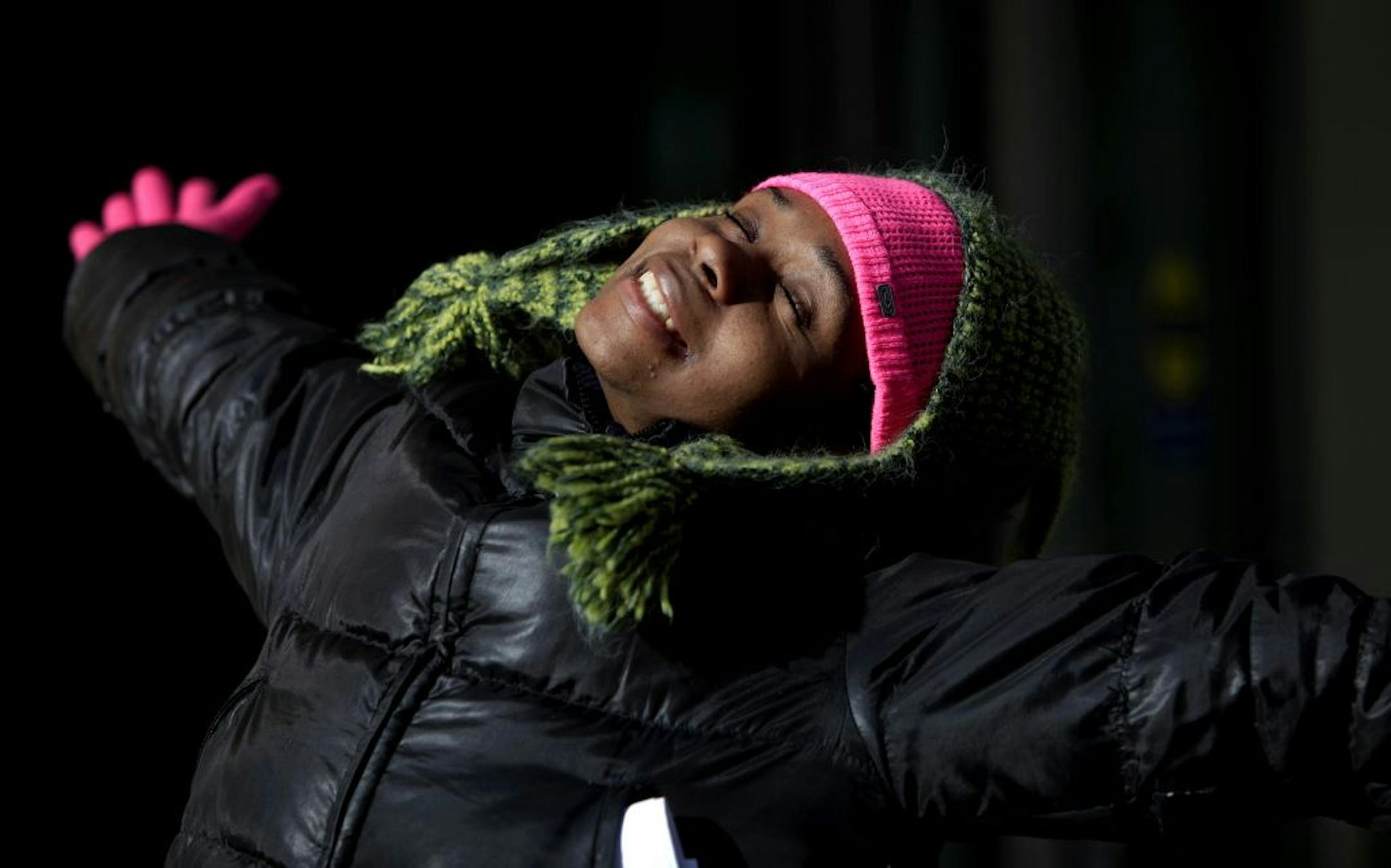 Sophia Gore of Schaumburg, Ill. , doubled up on hats to enjoy the sun in the 12-degree cold in Minneapolis on Monday. "I came to visit my sister in Minneapolis and had to wear two caps because it is so cold out," she said.