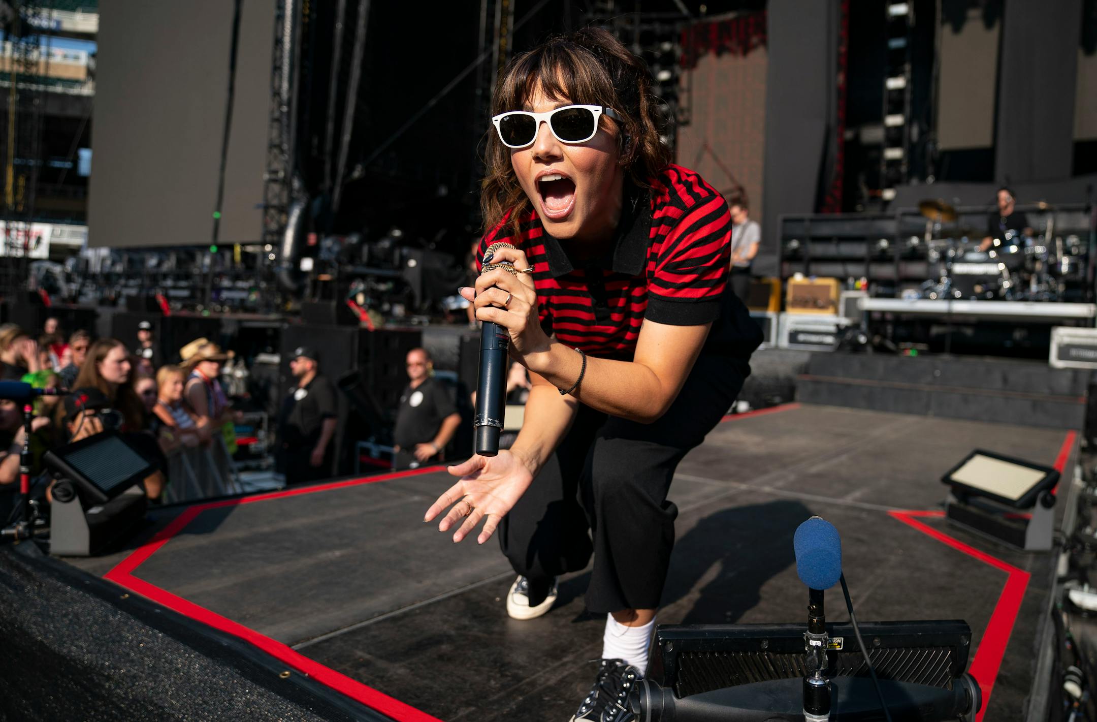 Aimee Allen, lead singer of The Interrupters, sang to the crowd at the end of the stage at Target Field as part of the Hella Mega Tour on Monday evening.