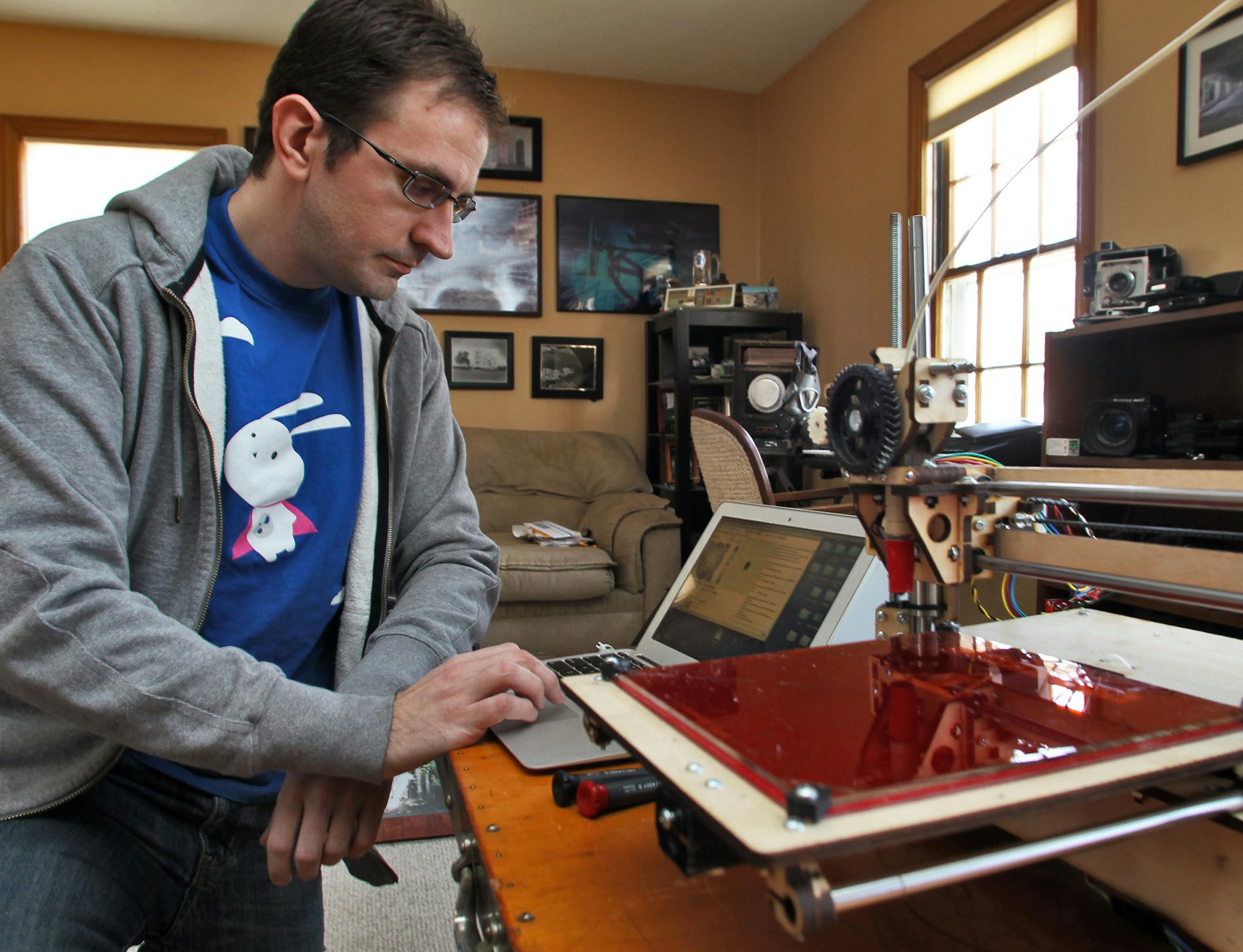 Dan Dockery of Minneapolis is a computer technology wizard who has built a 3-D printer designed to create plastic physical objects from a computer program. Here he created a small science fiction character called Cthulhu from a ribbon of ABS wound on a reel in a process that takes about an hour to complete. Dan Dockery started the process from his laptop. (MARLIN LEVISON/STARTRIBUNE(mlevison@startribune.com (cq Dan Dockery)