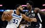 Brooklyn's Ed Davis guards the Timberwolves' Karl-Anthony Towns during the fourth quarter Monday.