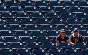 A couple of Twins fans watch Wednesday in hot, humid Tampa, where George Steinbrenner Field has been a lightly attended fill-in stadium — attendance