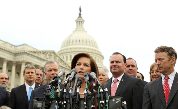 Rep. Michele Bachmann, R-Minn., chair of the Tea party Caucus, center, speaks on Capitol Hill in Washington, Thursday, May 16, 2013, during a news con