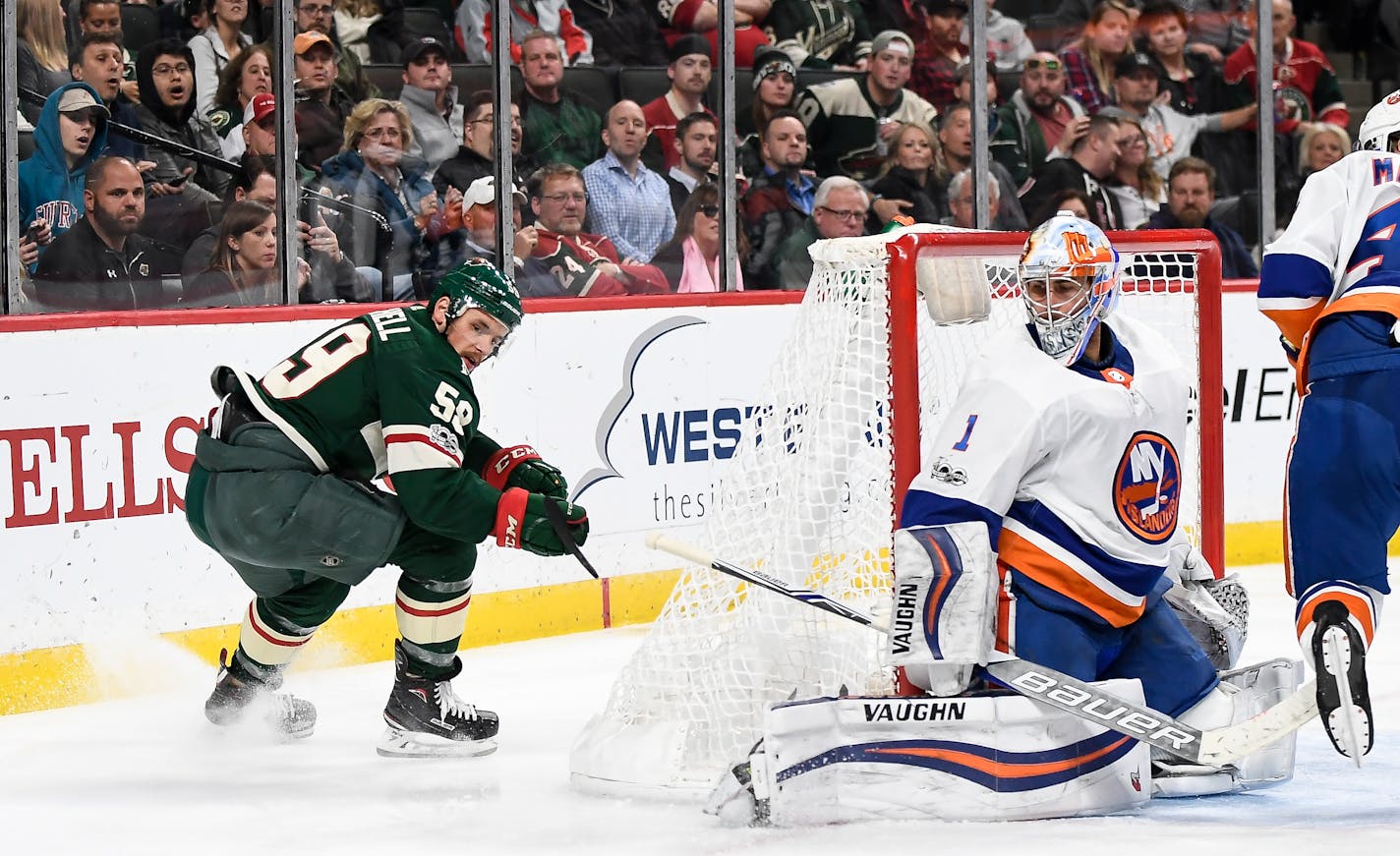 The Minnesota Wild's Zack Mitchell (59) turns around to see his puck sneak behind the leg padding of New York Islanders goalie Thomas Greiss (1) for Mitchell's first career NHL goal, in the third period on Thursday, Oct. 26, 2017, at Xcel Energy Center in St. Paul, Minn. The Wild won, 6-4. (Aaron Lavinsky/Minneapolis Star Tribune/TNS) ORG XMIT: 1214380