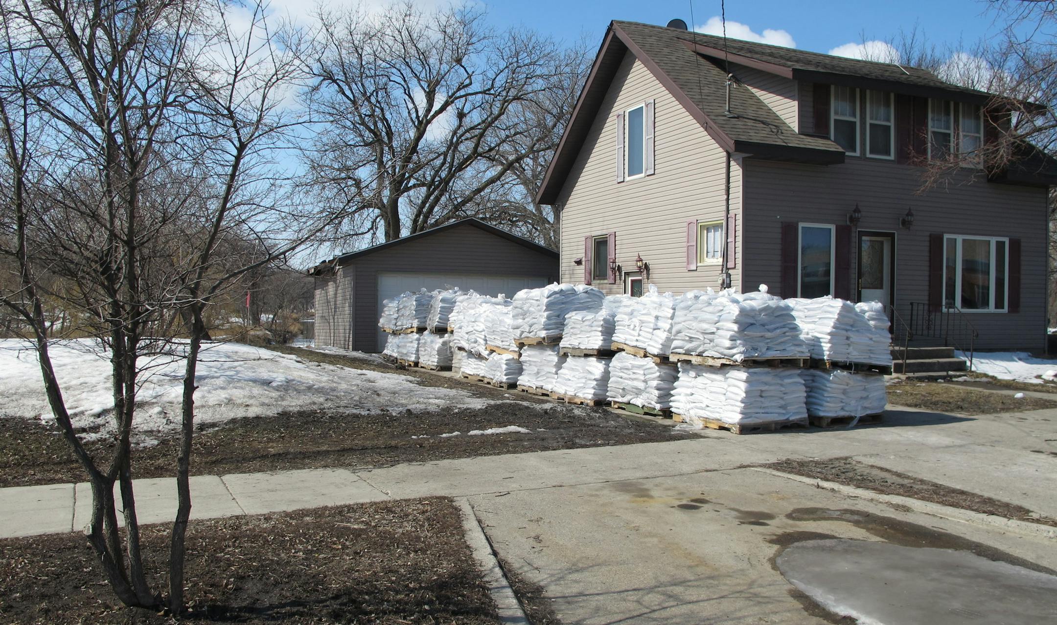 Palettes of sandbags are stacked in the driveway of this north Fargo, N.D. home on Tuesday, April 23, 2013, in preparation for the area's fourth major Red River flood in five years. (AP Photo/Dave Kolpack)