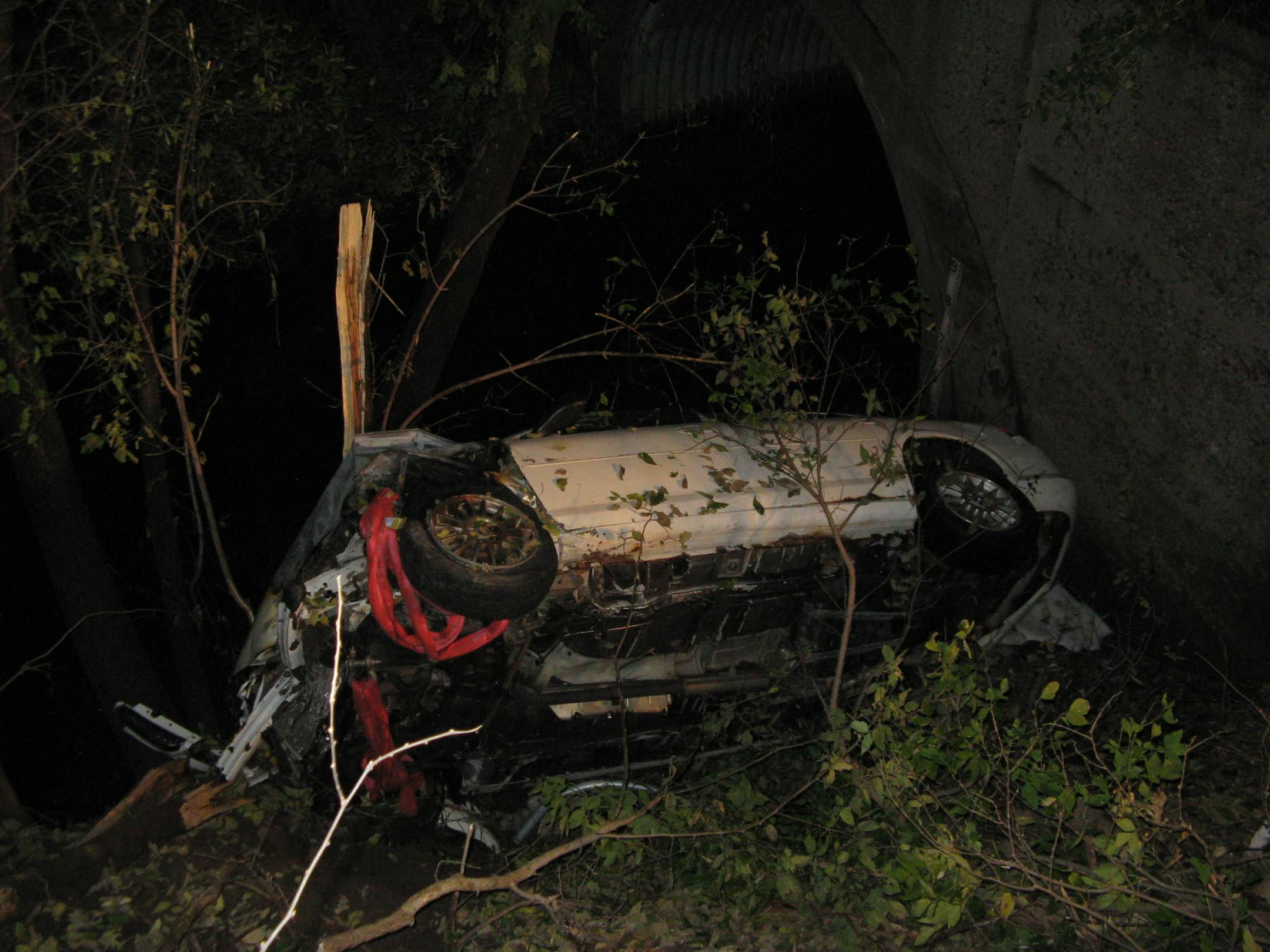 Emergency responders rescued a toddler from this car which was on fire after crashing into a creek and tipping over.