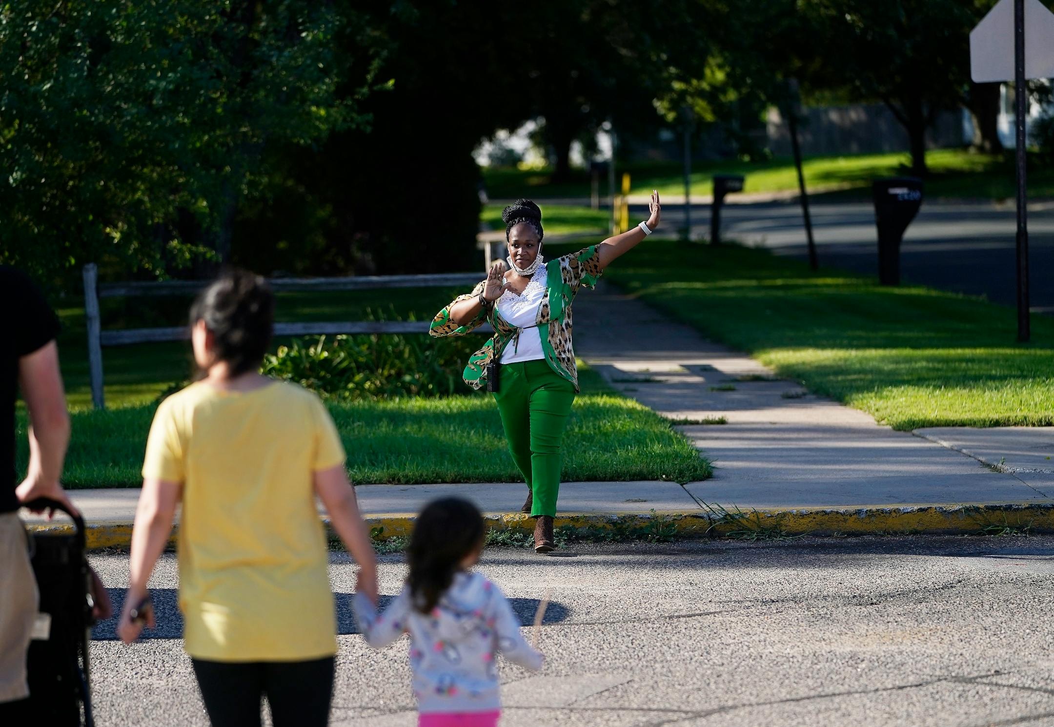 New Hoover Elementary School principal Keisha Davis directed traffic in the parking lot before the start of the first day of school Tuesday in Coon Rapids.   ]