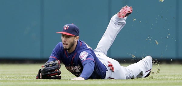 Minnesota Twins center fielder Jordan Schafer makes a stop on the single by Detroit Tigers' Anthony Gose during the fifth inning of a baseball game, W